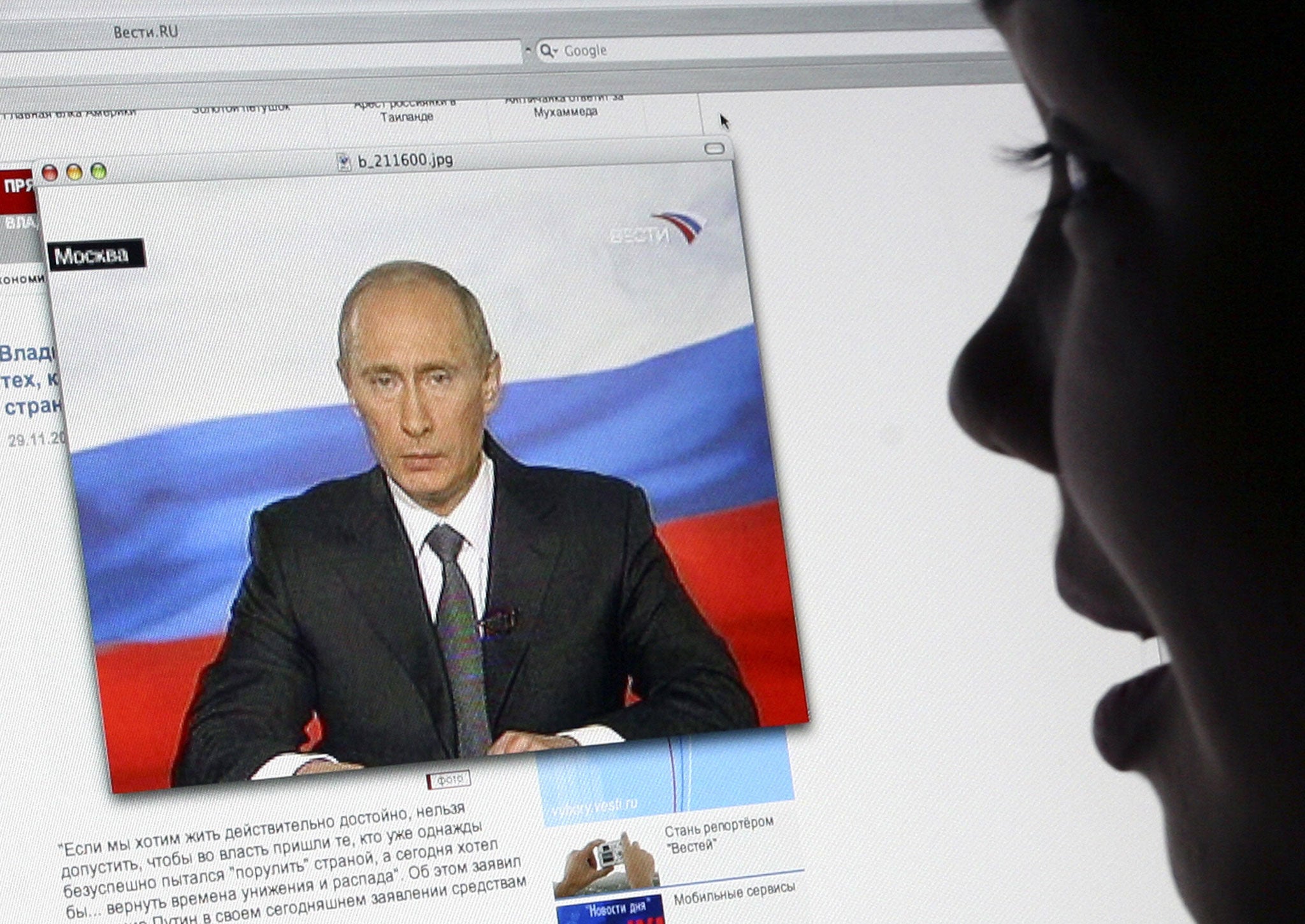 A girl watches Russian President Vladimir Putin's address to the nation on Russsian TV Channel One's website