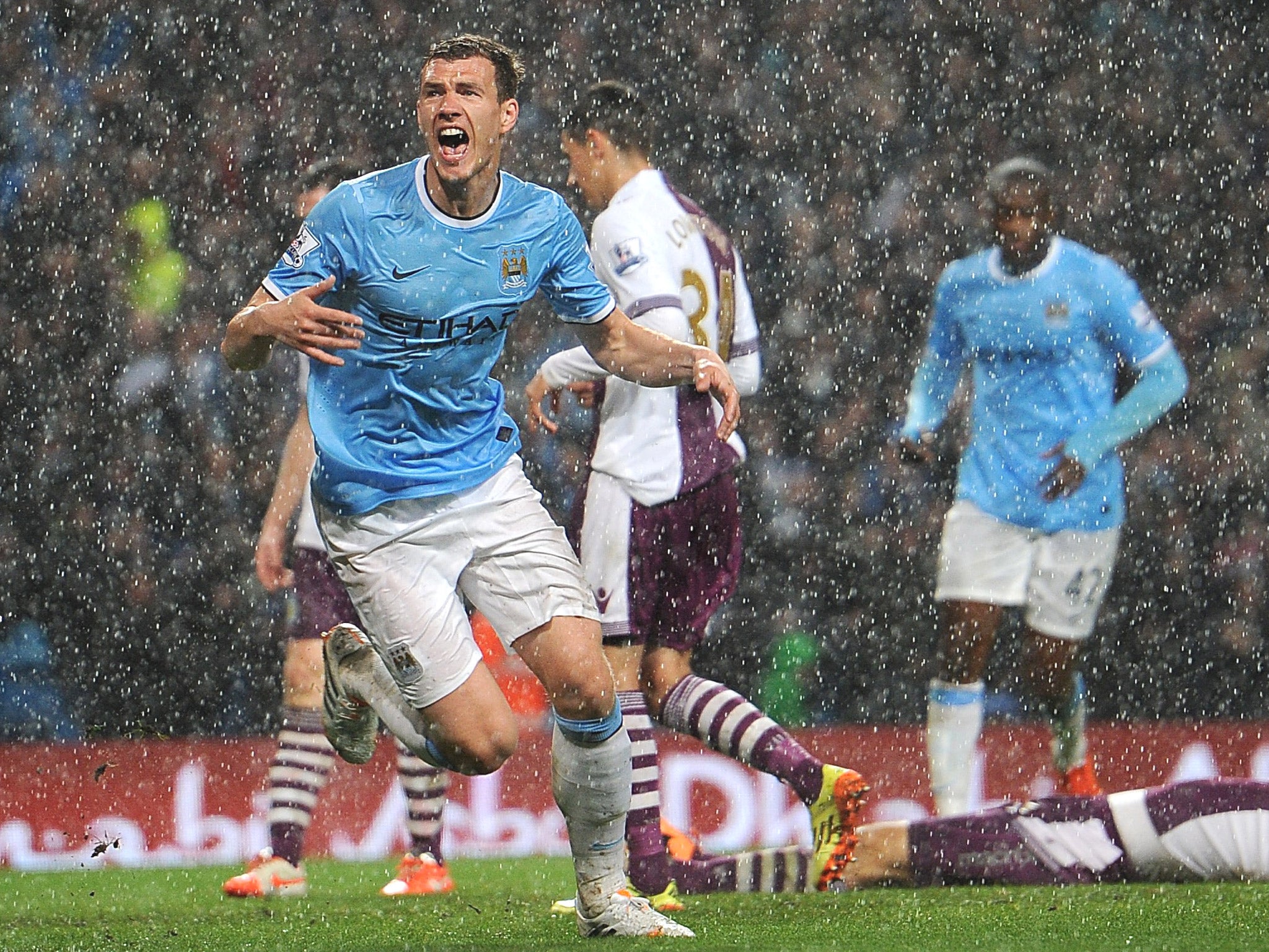 Edin Dzeko turns away after scoring Manchester City’s opening goal during a downpour at the Etihad Stadium