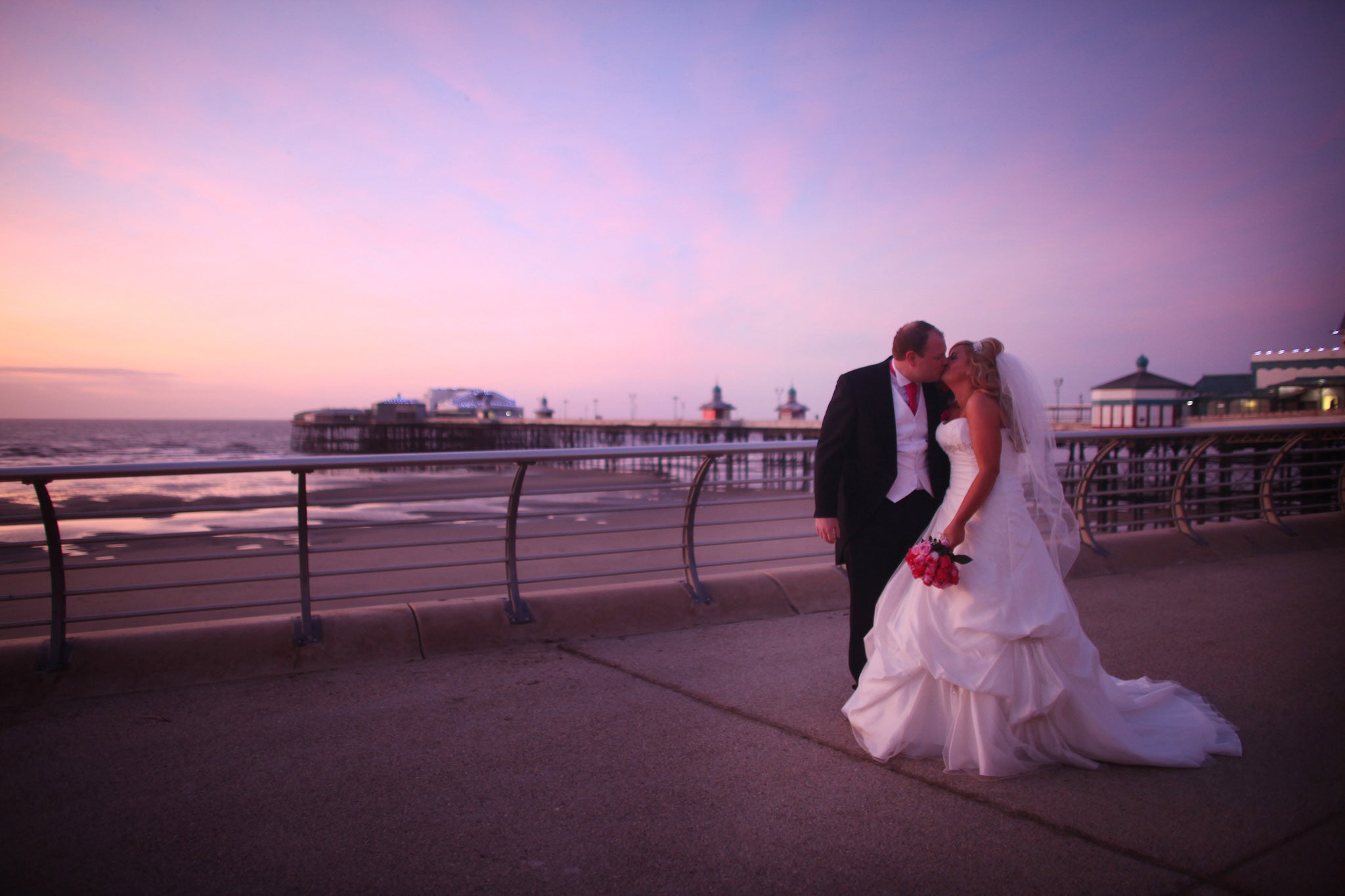 A newlywed couple kiss on Blackpool's promenade in January, 2012