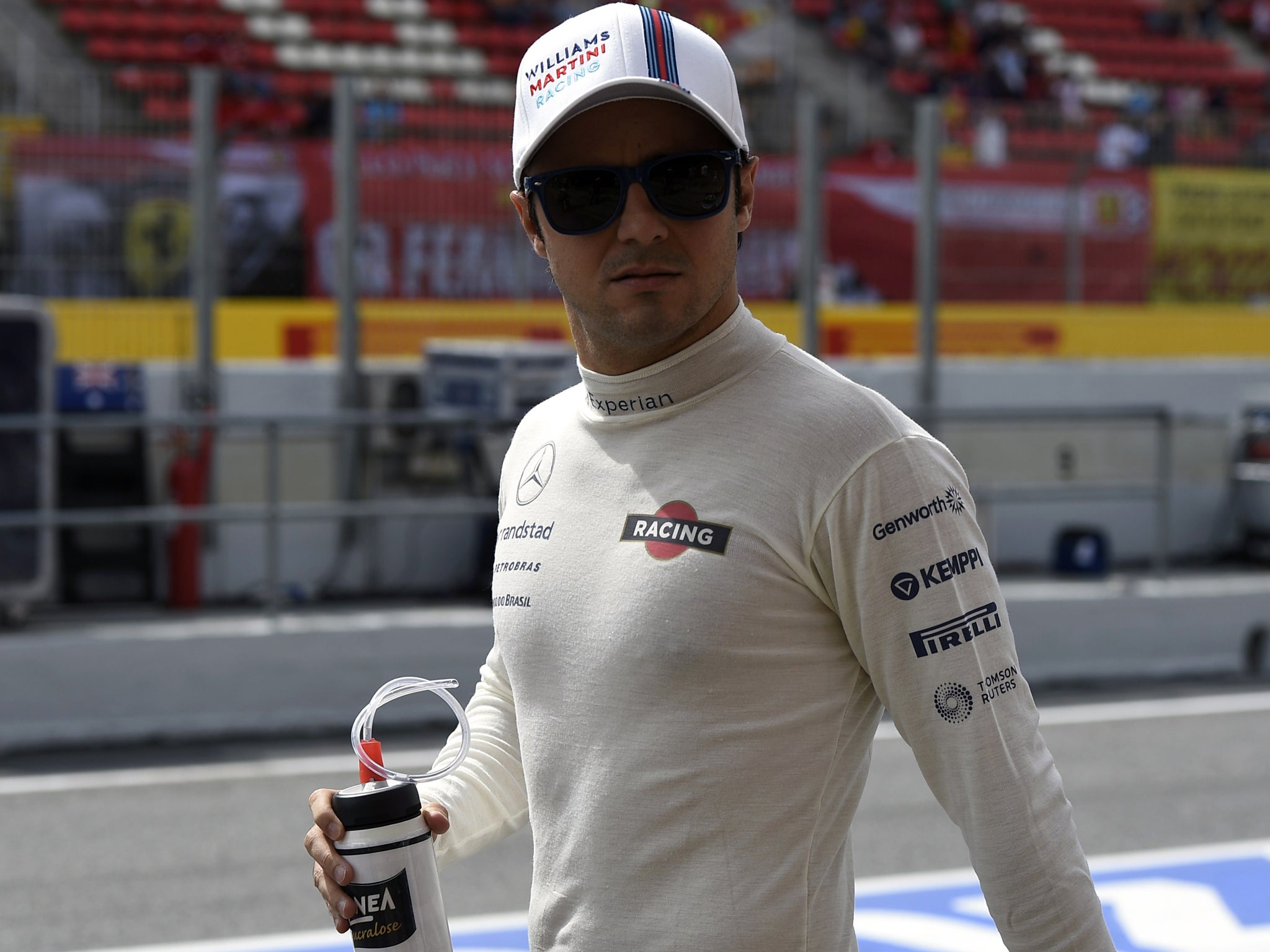 Massa walks through the pit-lane ahead of qualifying