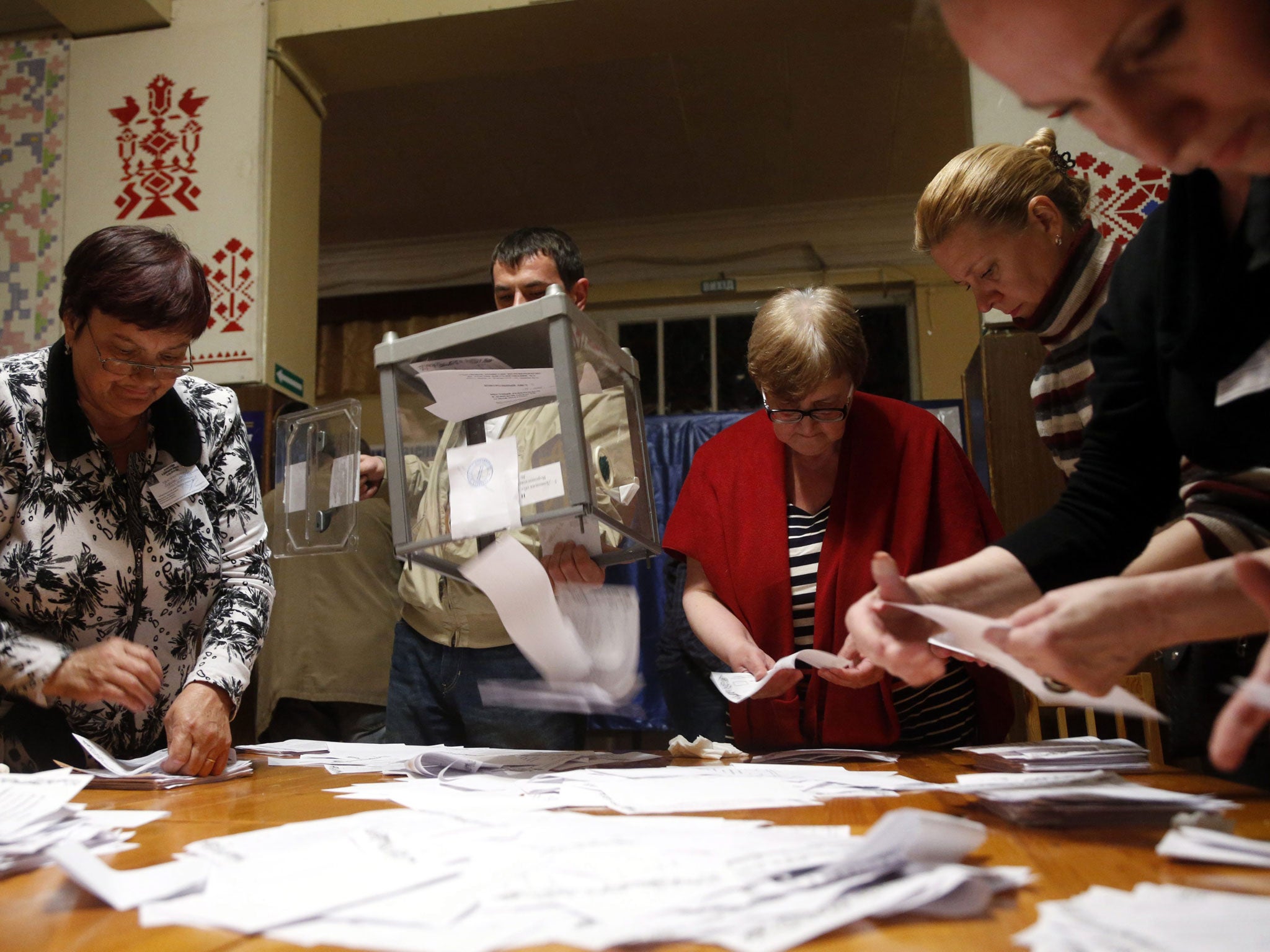 Members of a local election commission count votes after a referendum organized by the so-called Donetsk People's Republic members at a polling station in Donetsk, Ukraine