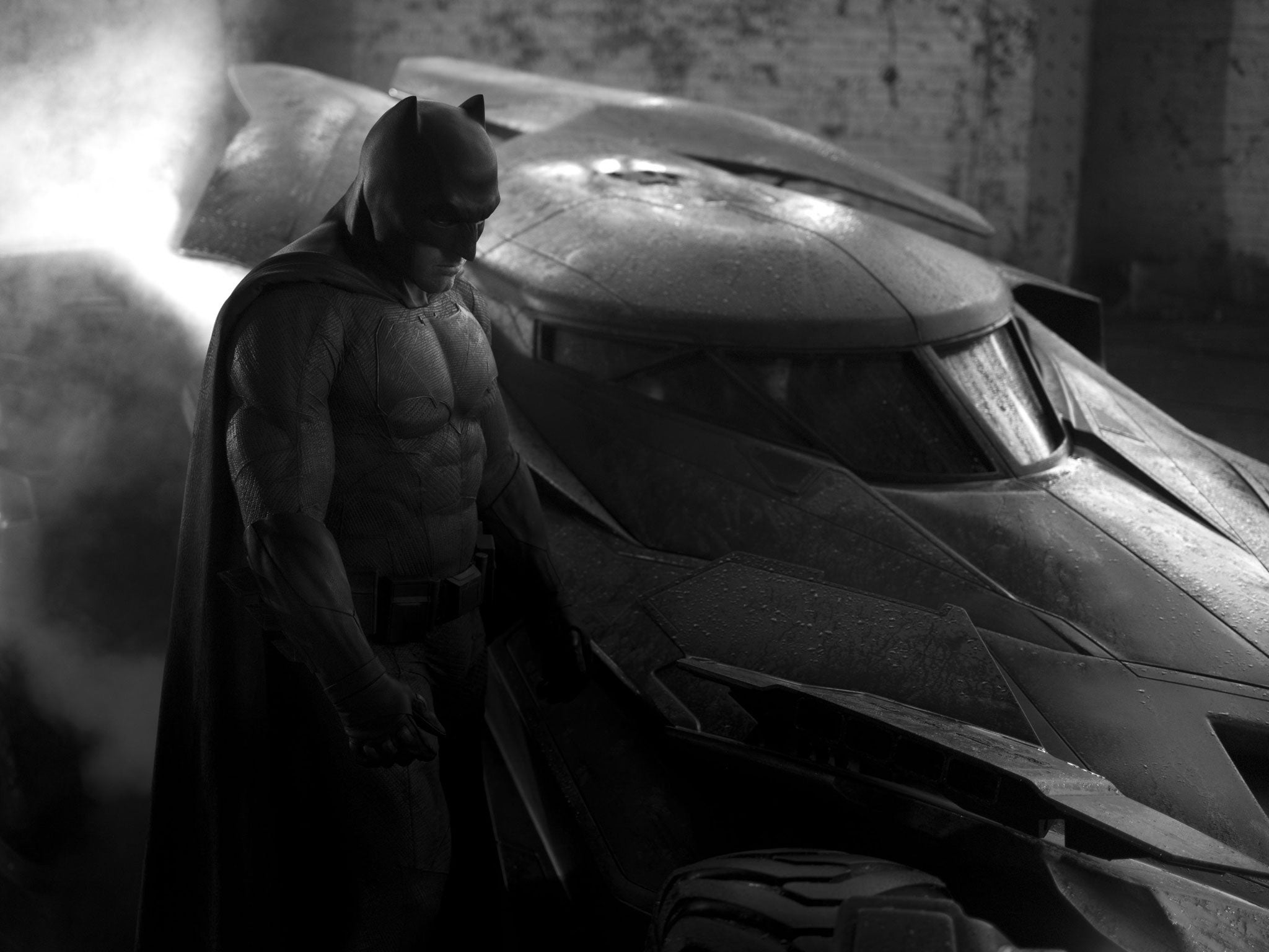 Ben Affleck as Batman with the batmobile in a Batman vs Superman teaser photo