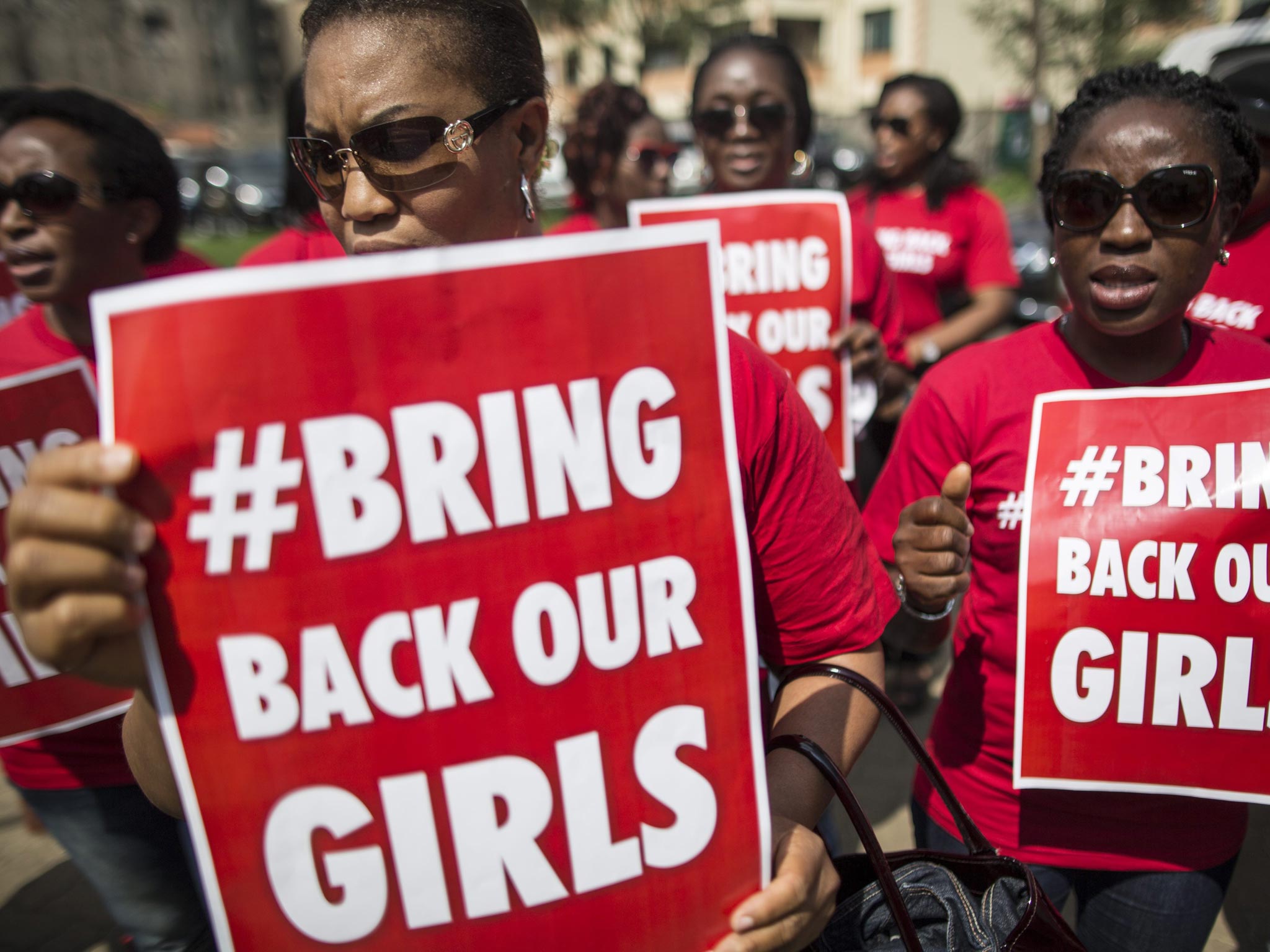 Nigerian women hold placards in front of the Nigerian High Commission during a protest against the kidnapping of the Nigerian school girls