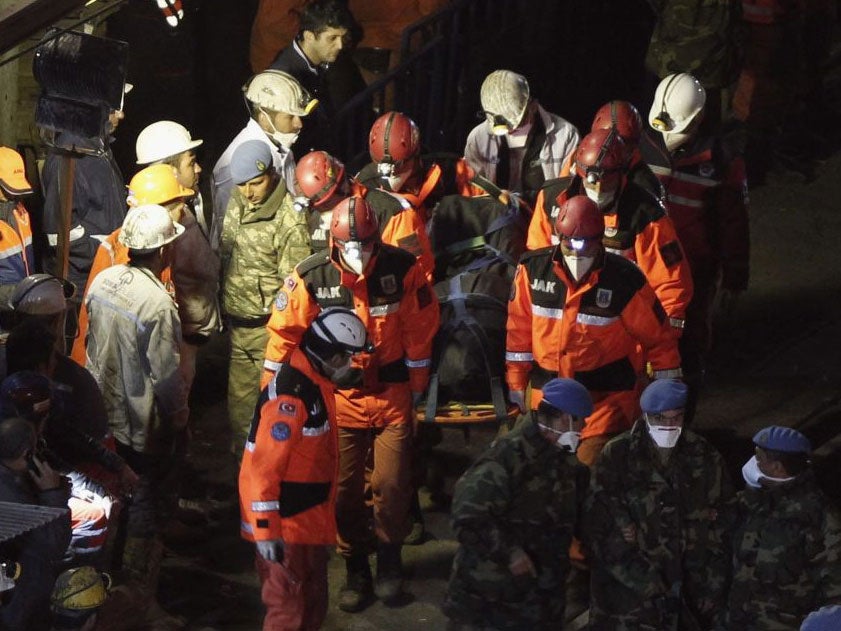 A body of miner is carried to an ambulance in Soma, a district in Turkey's western province of Manisa, late May 16, 2014.