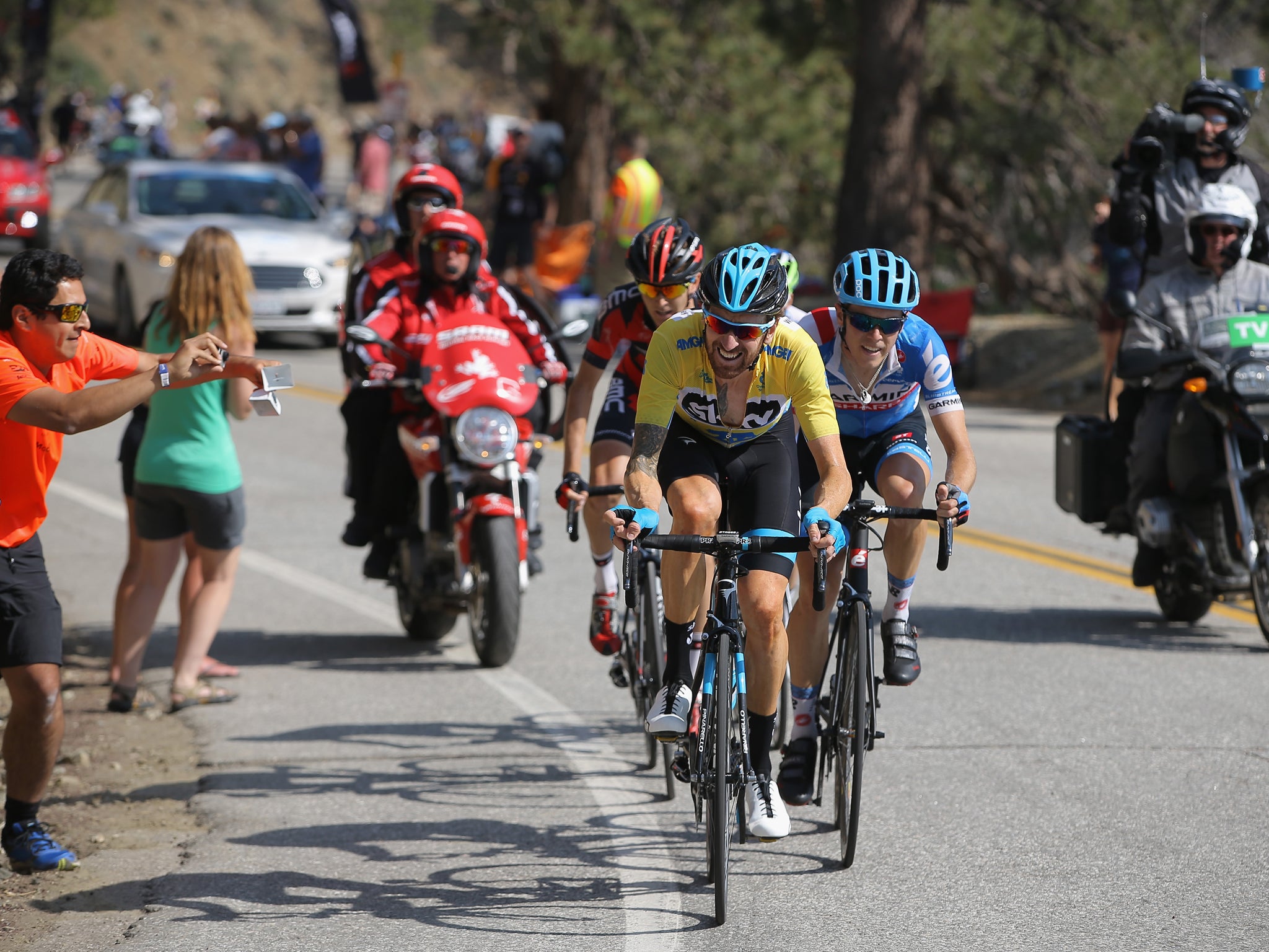 Bradley Wiggins of Great Britain riding for Team Sky defends the overall race leader's yellow jersey against Rohan Dennis of Australia riding for Team Garmin-Sharp