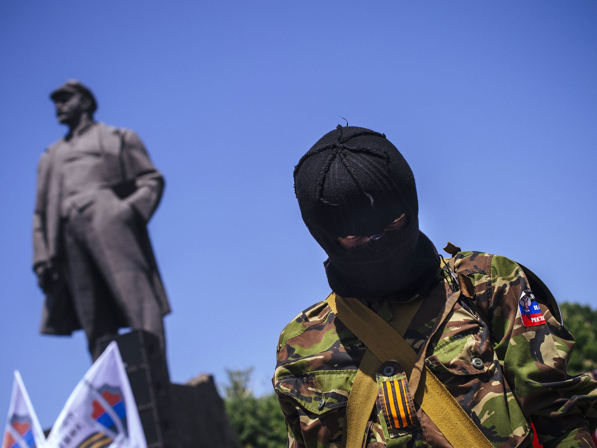 A masked pro-Russian activist attends a separatist rally in the eastern Ukrainian city of Donetsk