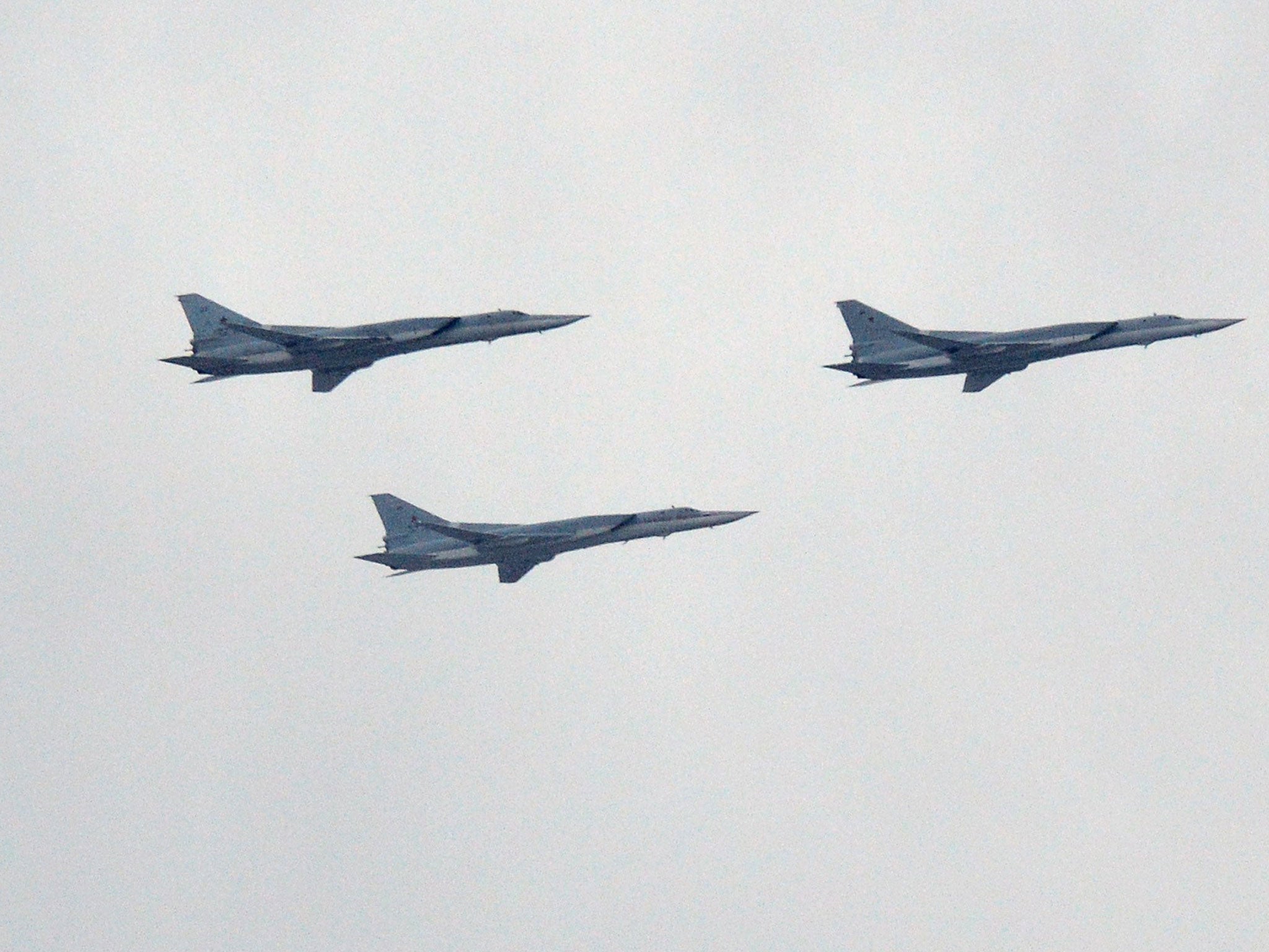 Russian Tupolev Tu-22M supersonic strategic bombers fly above the Kremlin's cathedrals in Moscow, on May 7, 2014, during a rehearsal of the Victory Day parade (Getty Images )