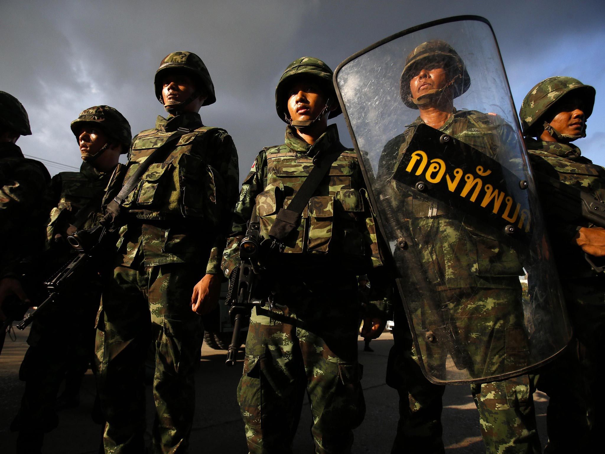 Soldiers stand guard during a coup at the Army Club where Thailand’s army chief held a meeting with all rival factions in central Bangkok yesterday