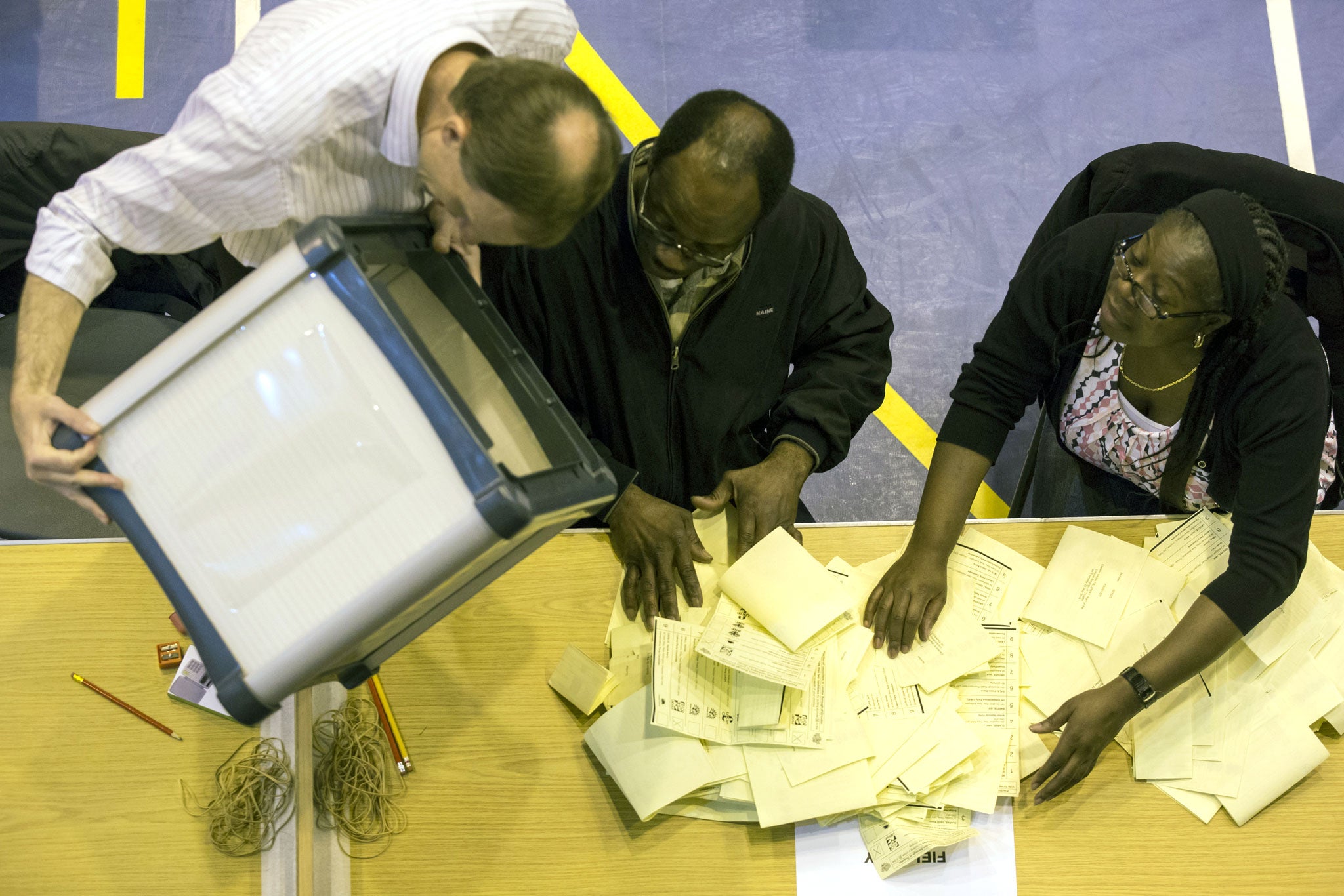 A ballot box containing votes in local elections is emptied at Trinity School in Croydon