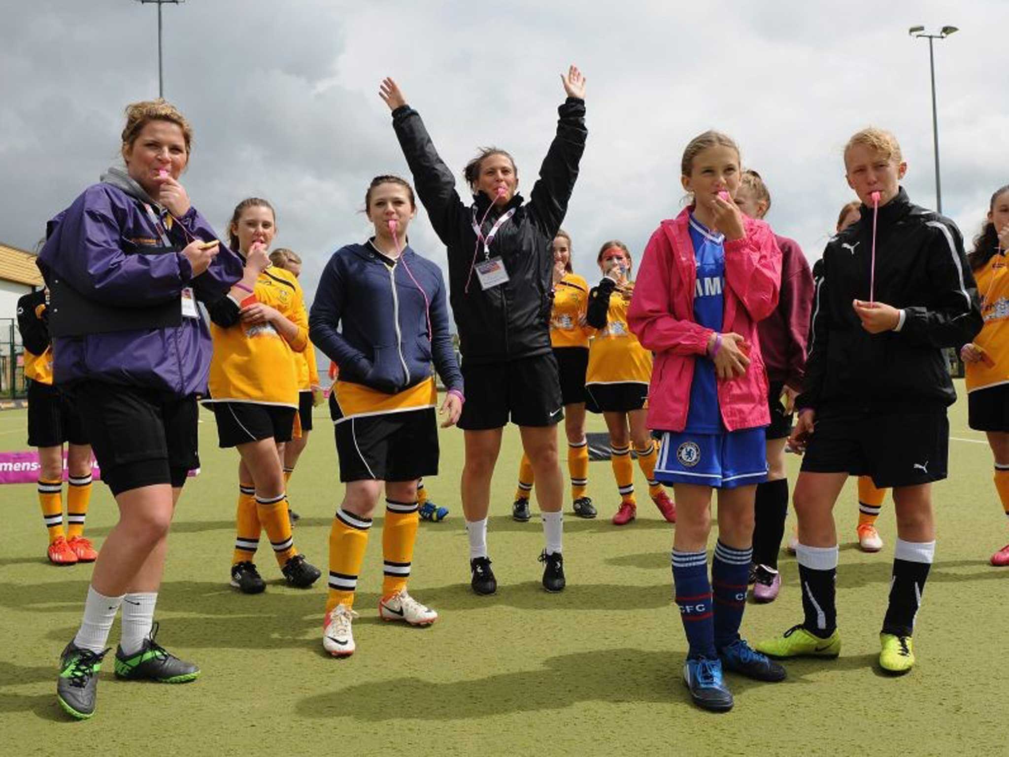 Girls getting fit and enjoying football in a refereeing workshop