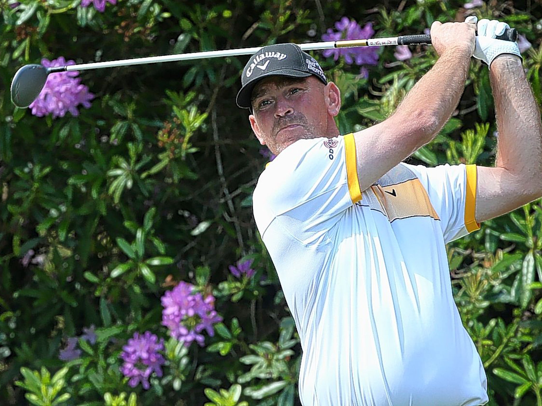 Petal Power: Thomas Bjorn plays his tee shot on the seventh hole at Virginia Water on his way to a remarkable round of 67