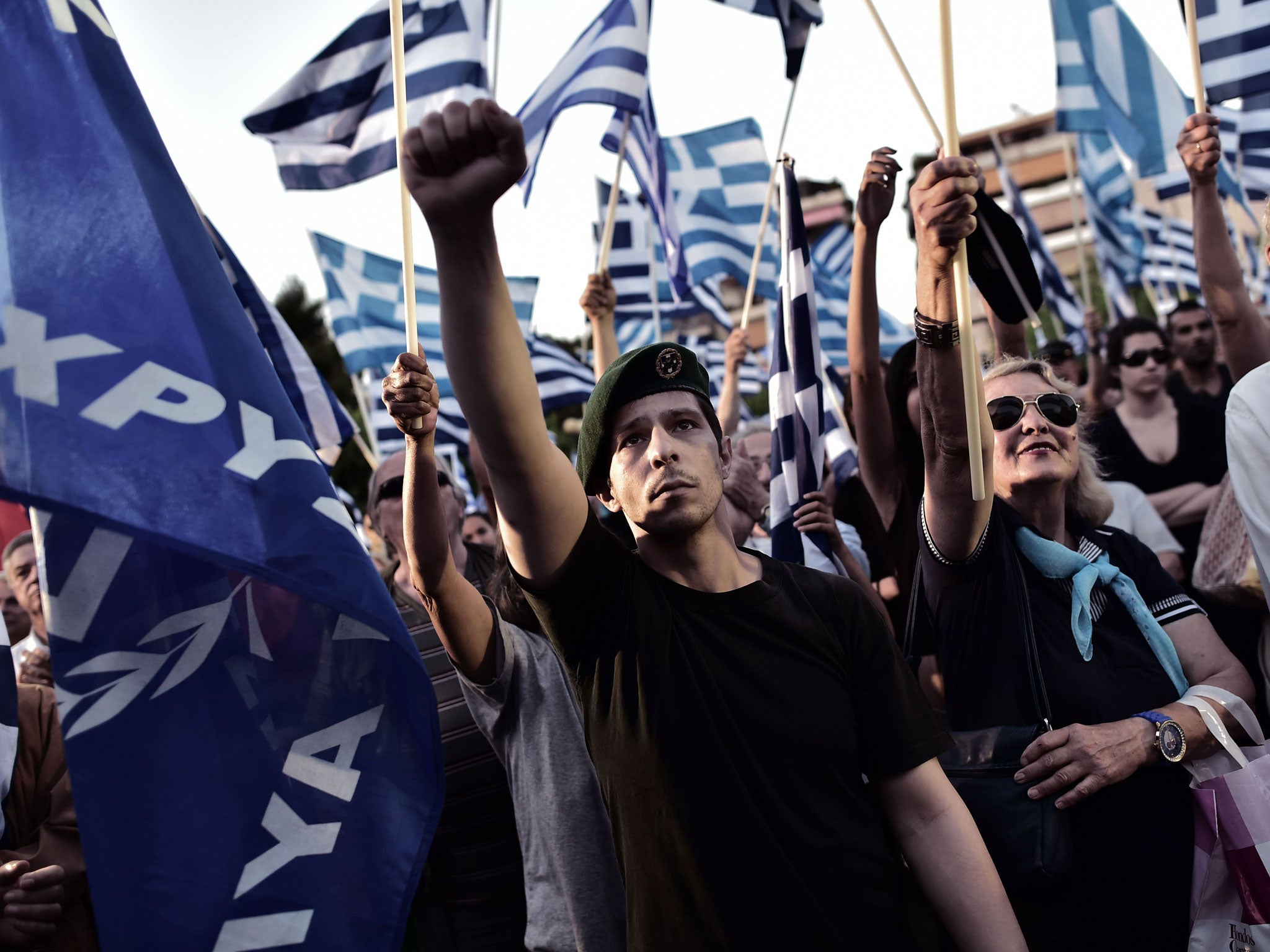 A supporter of the Greek ultra nationalist party Golden Dawn raises his fist during a pre-election rally in Athens