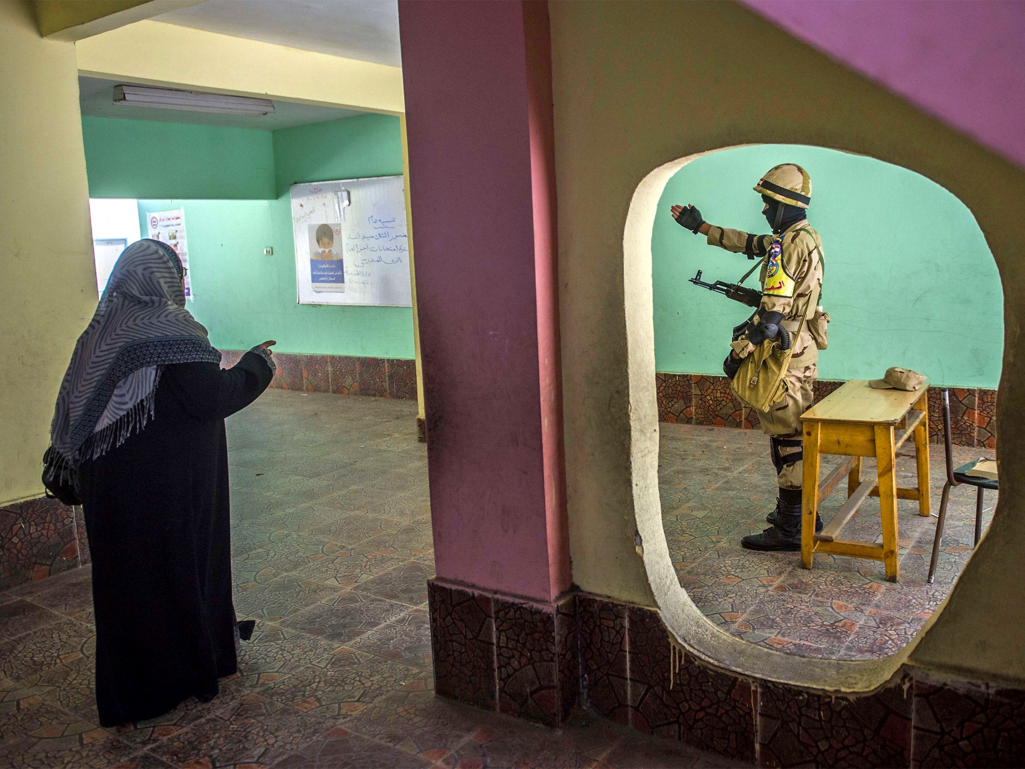 Voting in Cairo; there are reports of empty polling stations despite government employees allegedly being threatened with a wage cut if they do not vote