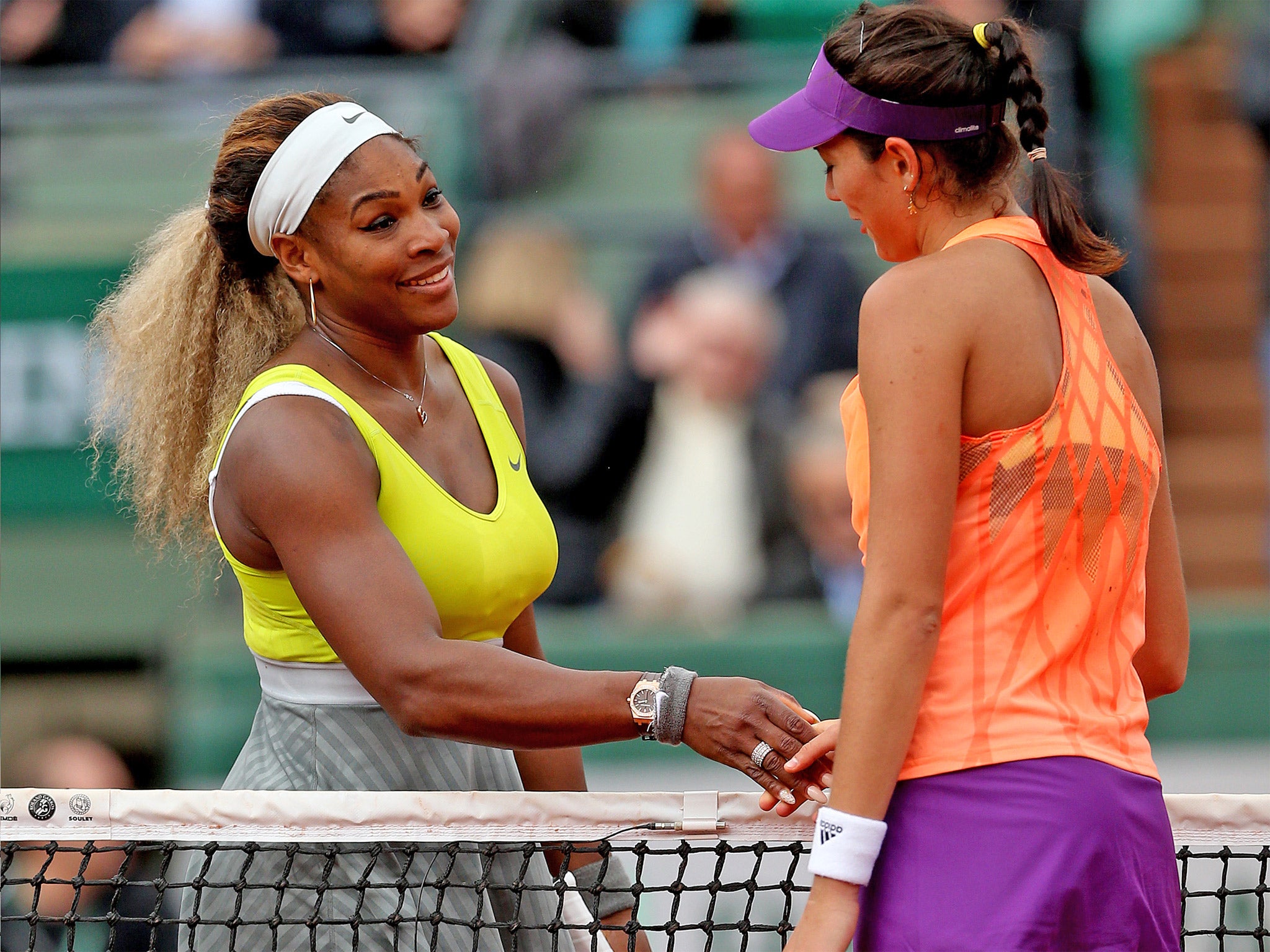 Garbine Muguruza shakes hands with Serena Williams at the net following her victory