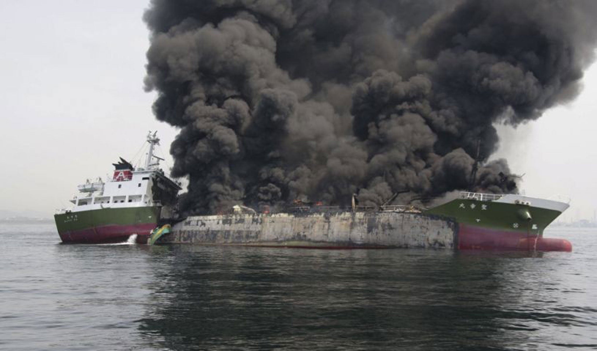 This photo, released by Japan's 5th Regional Coast Guard, shows clouds of black smoke billowing from the 998-tonne Shoko Maru, after it exploded off the southwest coast near Himeji port