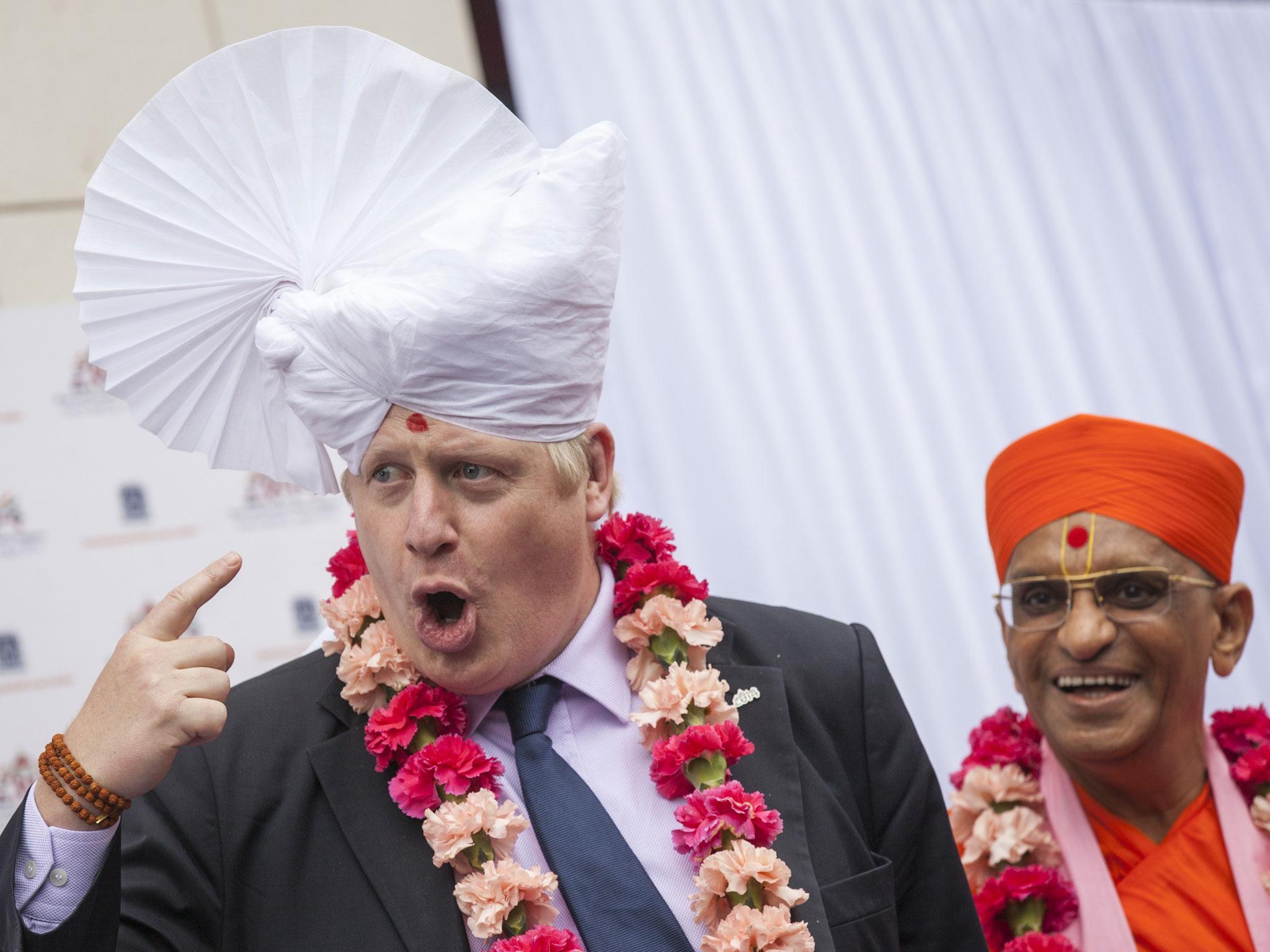 The Mayor of London Boris Johnson wears a traditional headdress during a visit to the Shree Swaminarayan Mandir, a major new Hindu temple being built in Kingsbury in London.