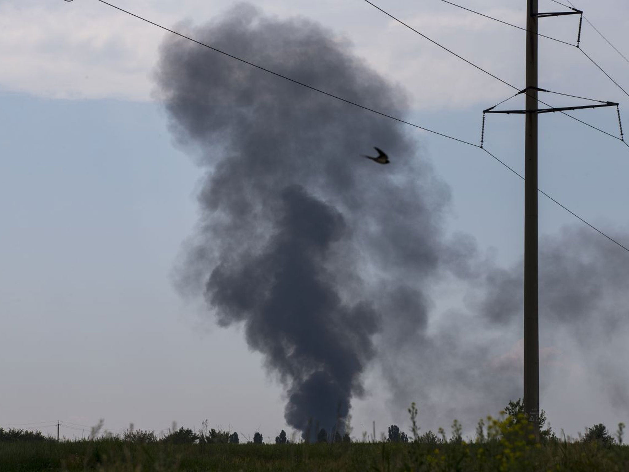 Black smoke rises from a shot down Ukrainian Army helicopter outside Slovyansk