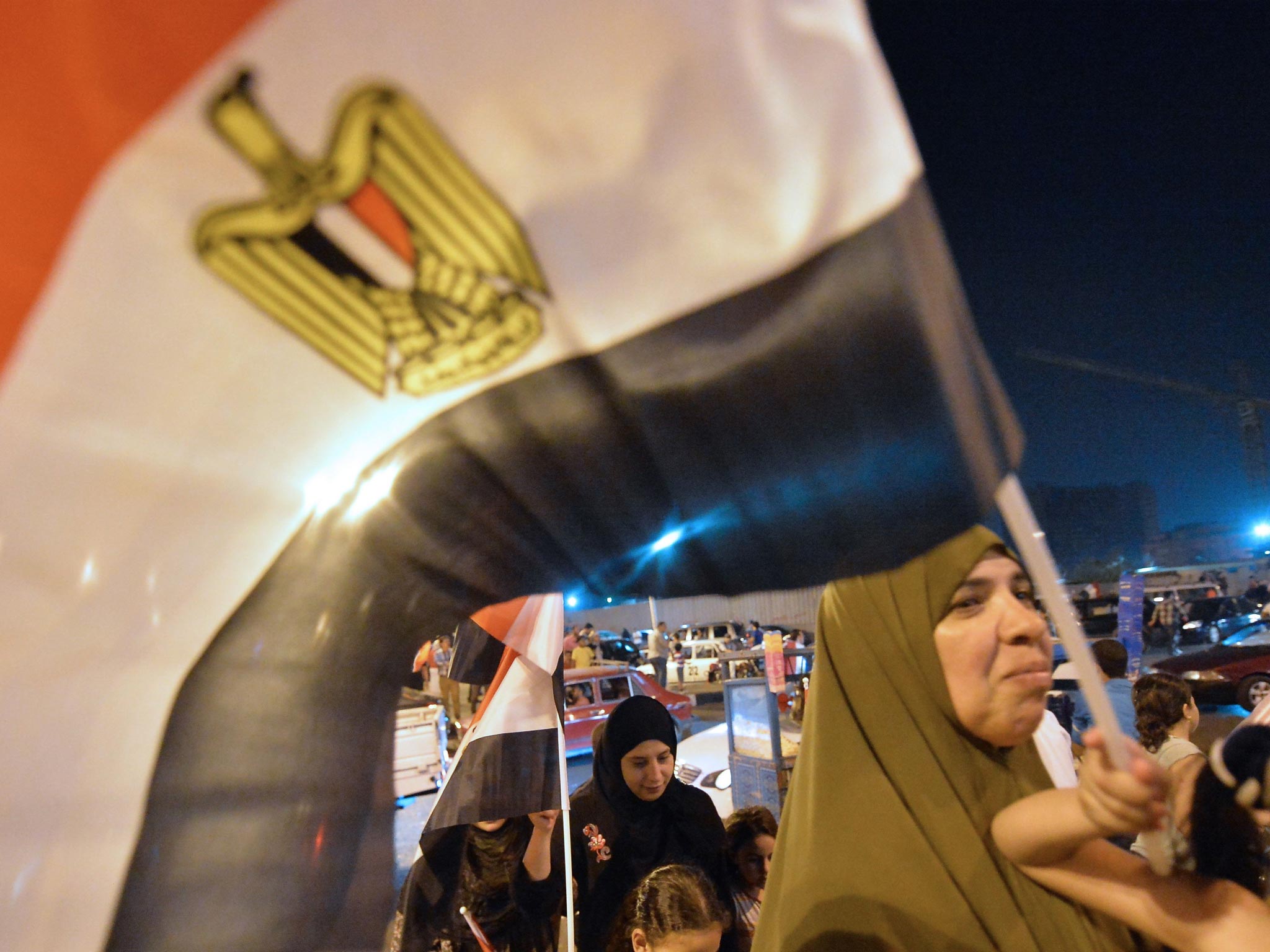 Supporters of Egyptian presidential candidate and former army chief Abdel Fattah al-Sisi wave Egyptian flags as they celebrate in a street in Cairo