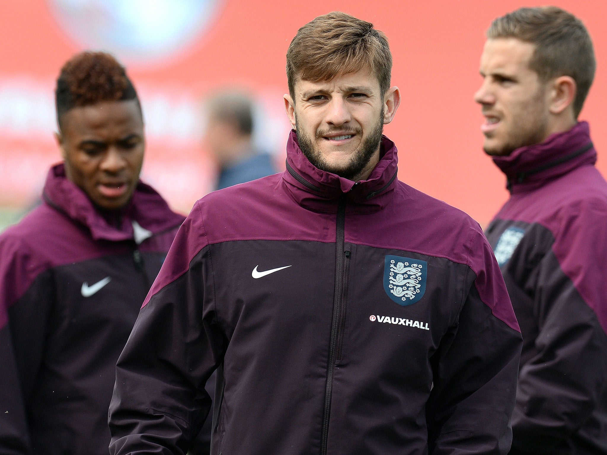 England's Adam Lallana (C), Raheem Sterling (L) and Jordan Henderson attend a training session at St George's Park training complex in Burton-on Trent, central England