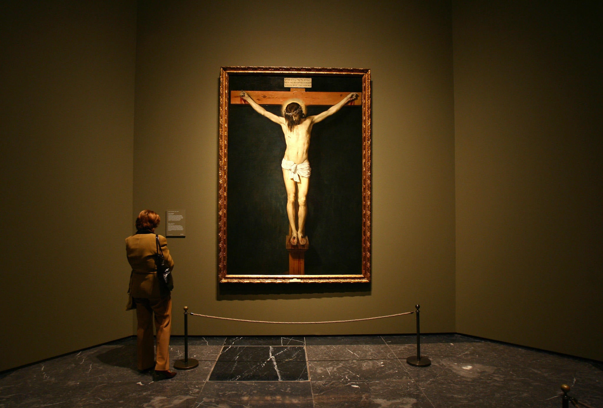 A woman looks at a painting by Spanish artist Diego Velazquez at the Prado museum.