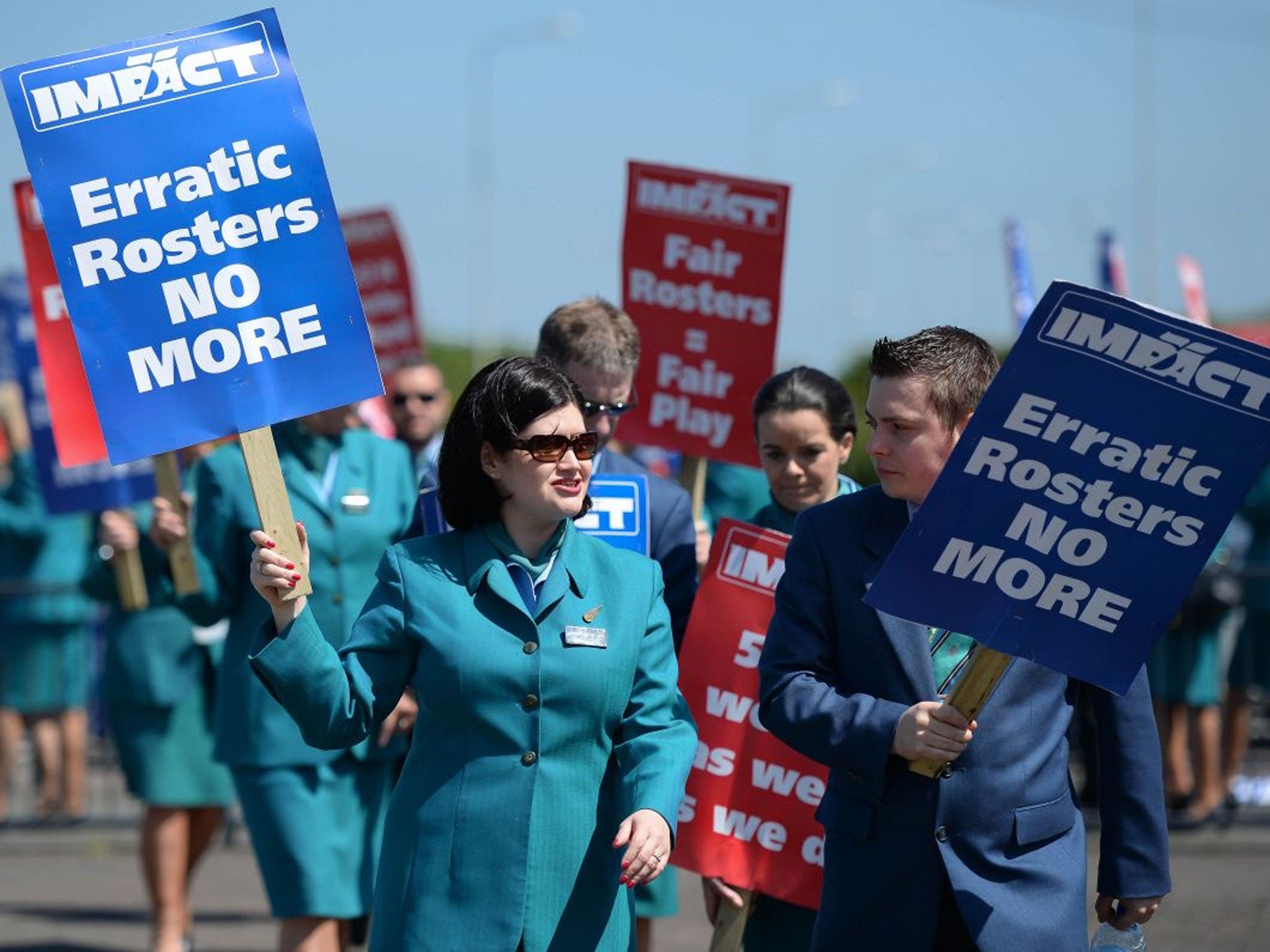 Aer Lingus staff at the entrance to Dublin Airport as 200 flights have been disrupted by an Aer Lingus cabin crew strike at the start of the bank holiday weekend in Ireland.