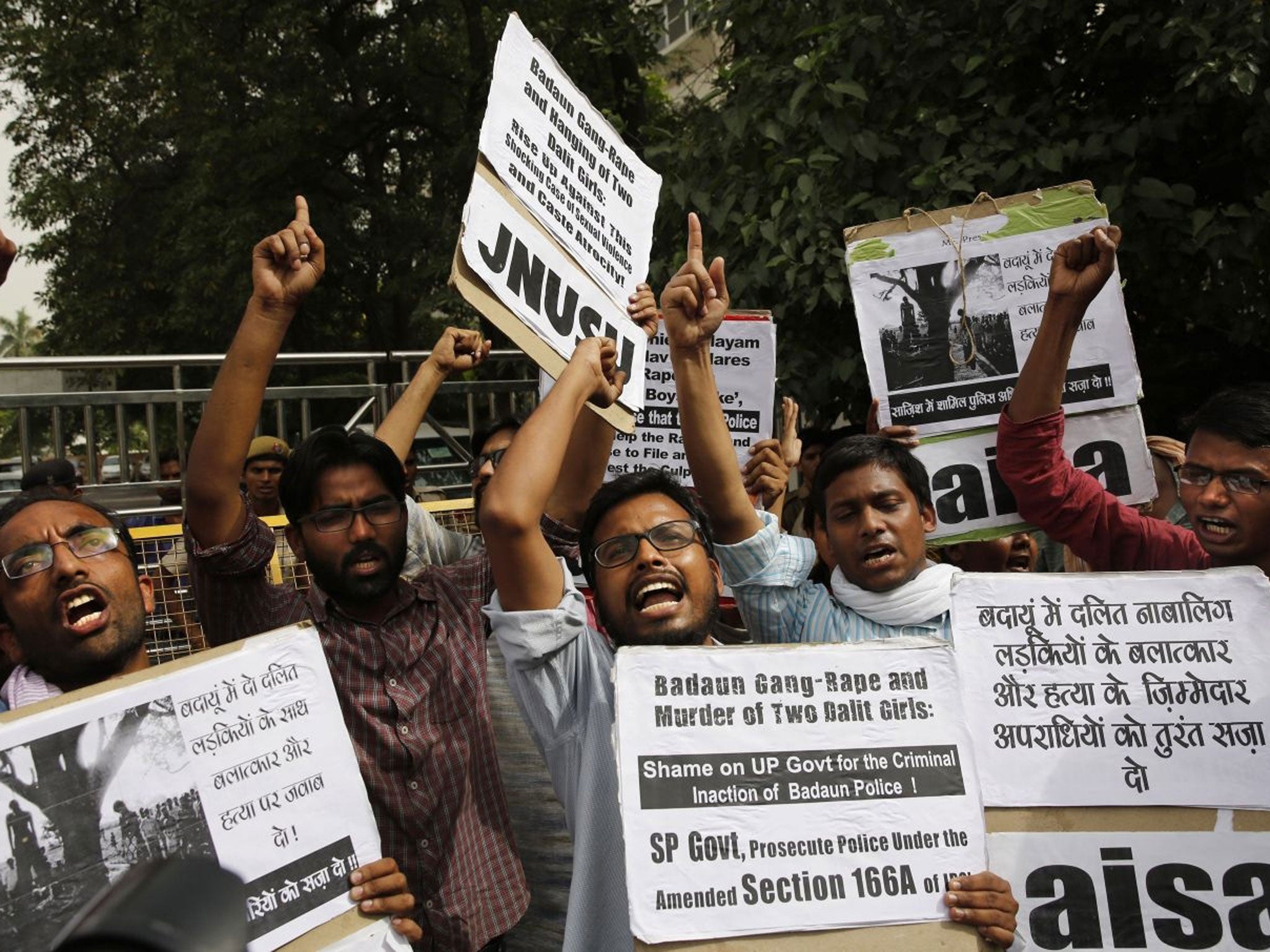 Members of Jawaharlal Nehru University Students Union shout slogans during a protest against a gang rape of two teenage girls in Katra village, outside the Uttar Pradesh state house, in New Delhi, India, Friday, May 30, 2014. A top government official sai