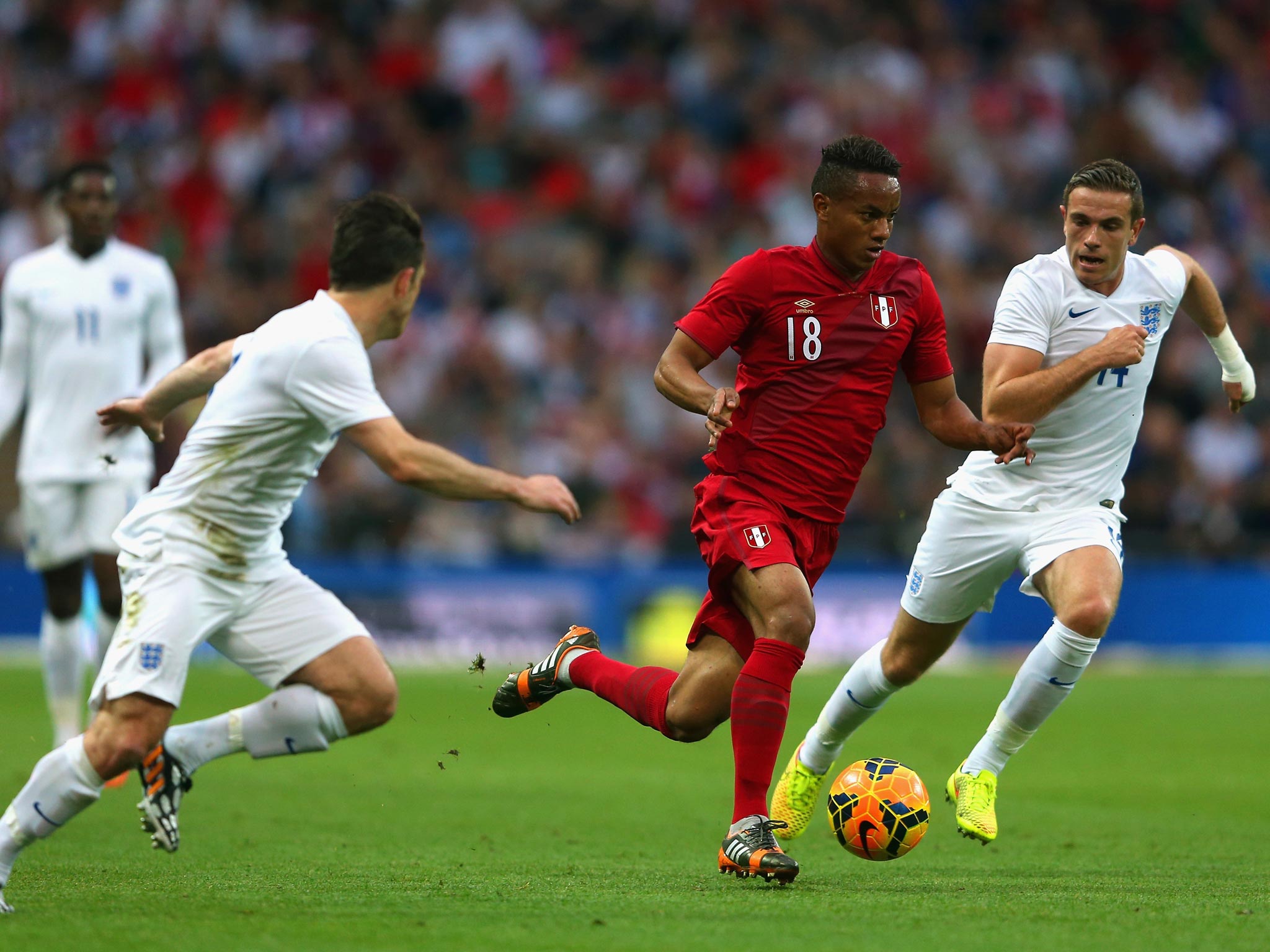 Andre Carrillo of Peru is closed down by Leighton Baines and Jordan Henderson of England during the international friendly match between England and Peru at Wembley Stadium