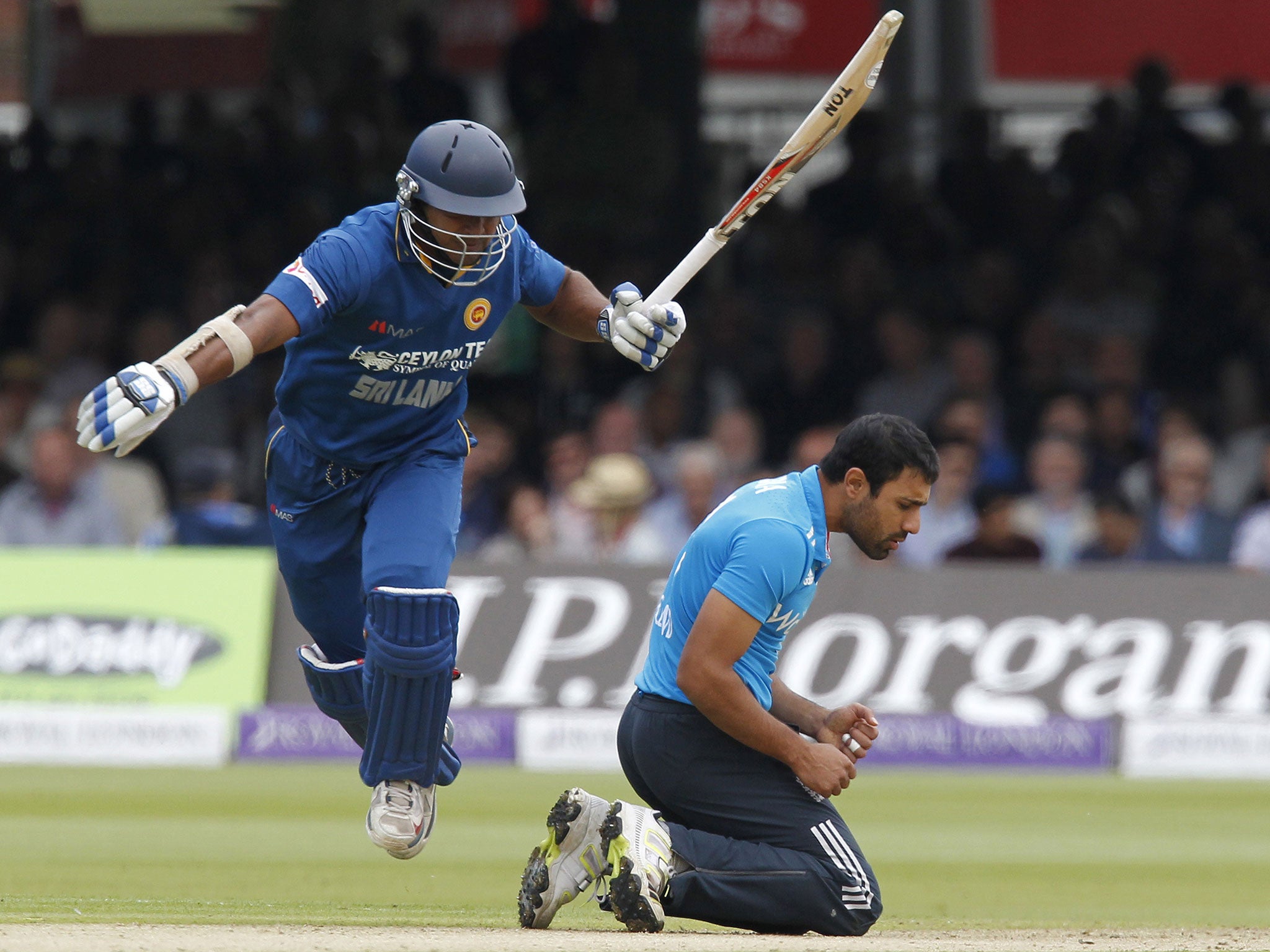 Sri Lankas Kumar Sangakkara runs between the wickets avoiding Englands Ravi Bopara (R) during the fourth One-Day International (ODI) cricket match between England and Sri Lanka at Lord's