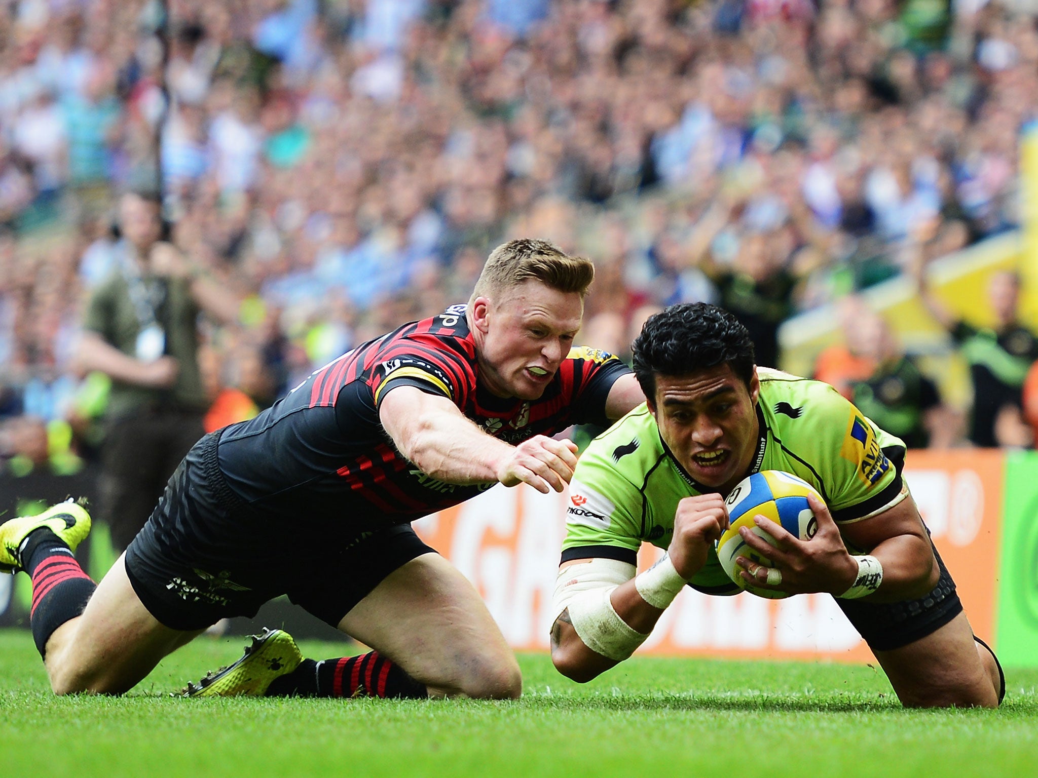 Chris Ashton of Saracens fails to stop George Pisi of Northampton Saints goes over to score their second try