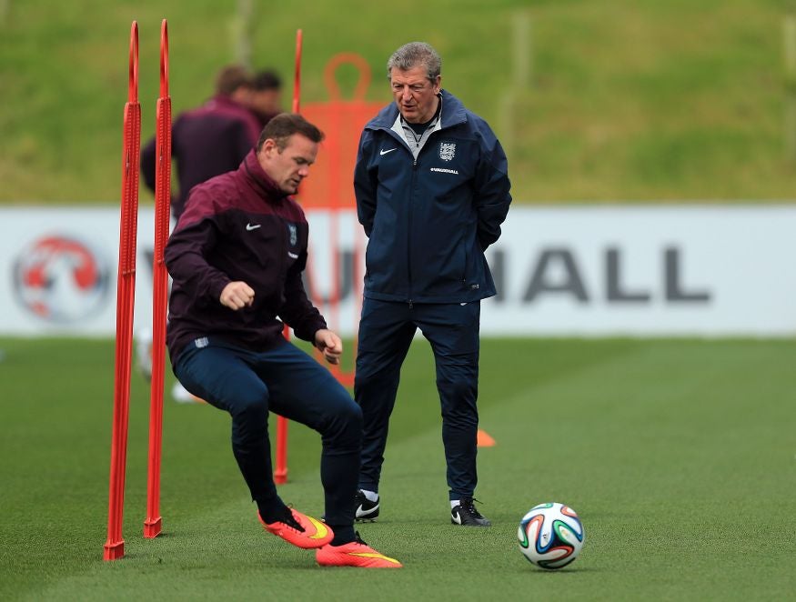 Rooney trains under the watchful gaze of Roy Hodgson