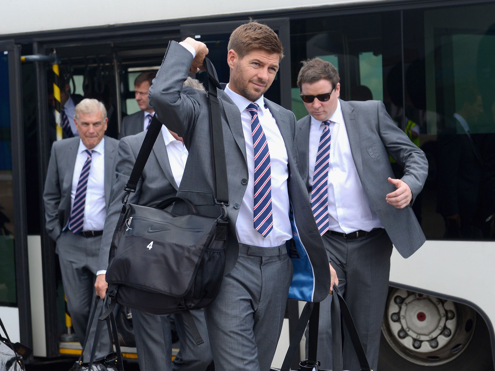 England captain Steven Gerrard prepares to board a plane leaving for the 2014 Brazil World Cup