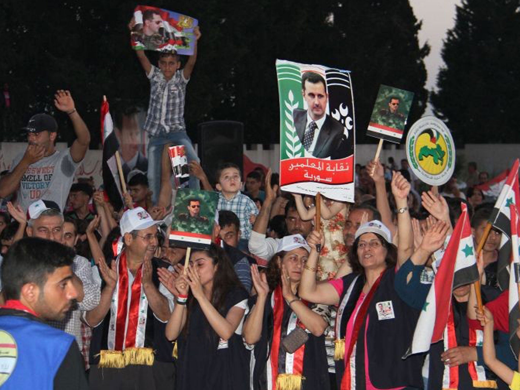 Supporters of Syrian President Bashar Assad demonstrate in support of his candidacy for president during elections last year