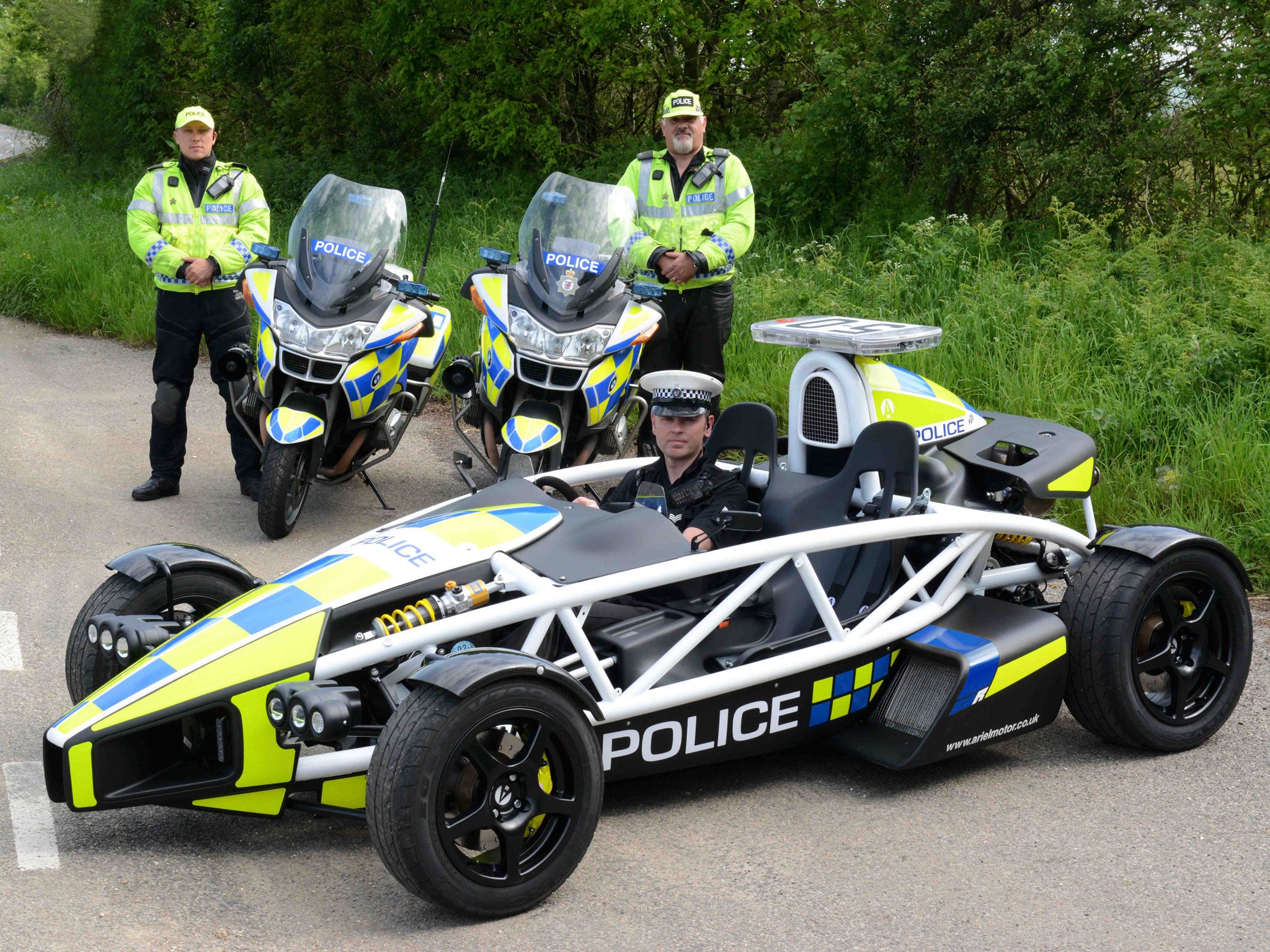 Sergeant Andy Parsons (sat in the Atom) said the campaign was to raise awareness about motorbike safety. Avon and Somerset Police's PC Mark Cummings (left) and PC Pete Wilson (right) beside their own bikes