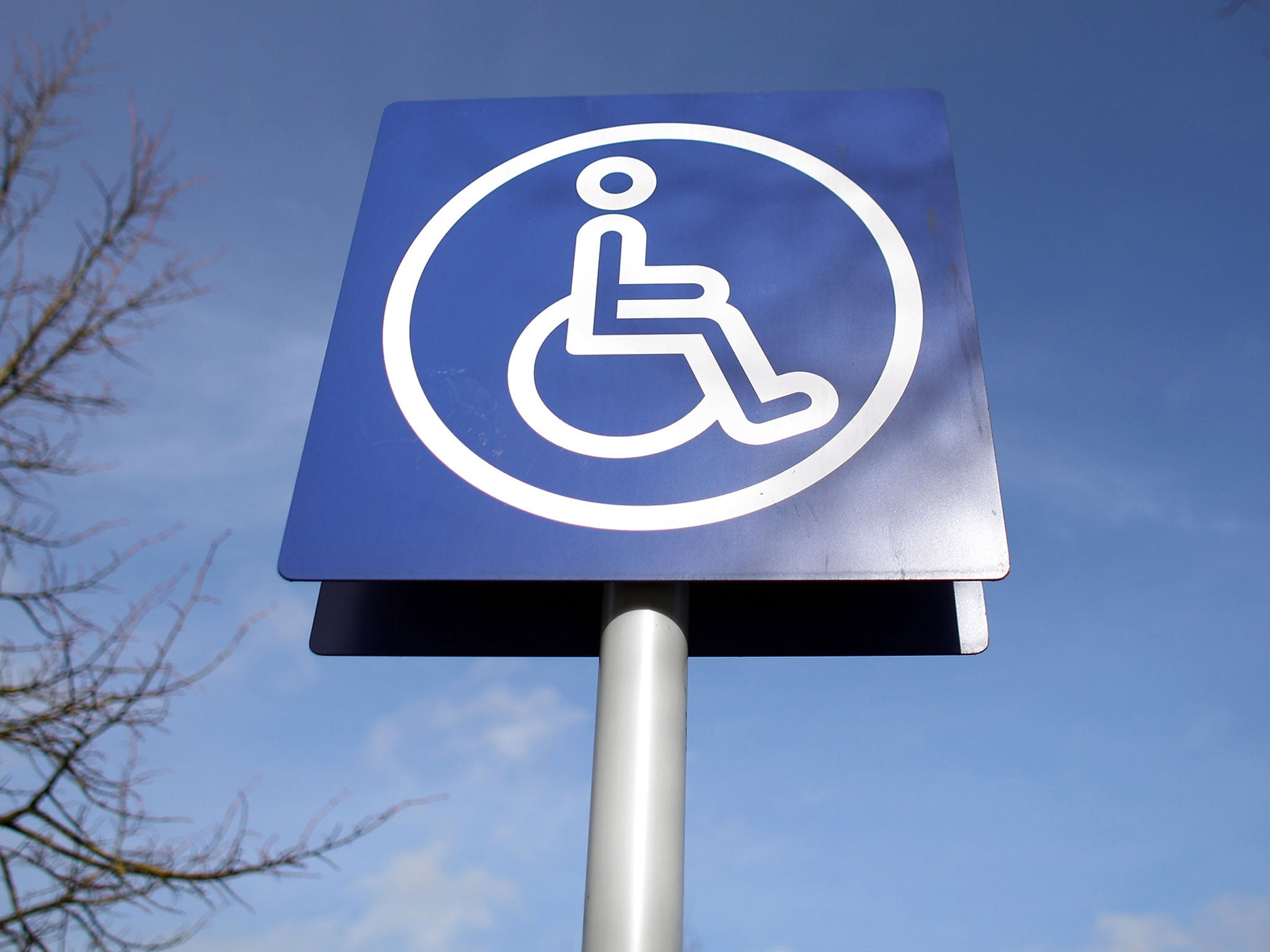 A sign is displayed above a disabled car parking bay on February 16, 2011 in Bath, England. The government is currently considering a range of measures after it was revealed that the system - which allows badge holders free parking in many pay-and-displa