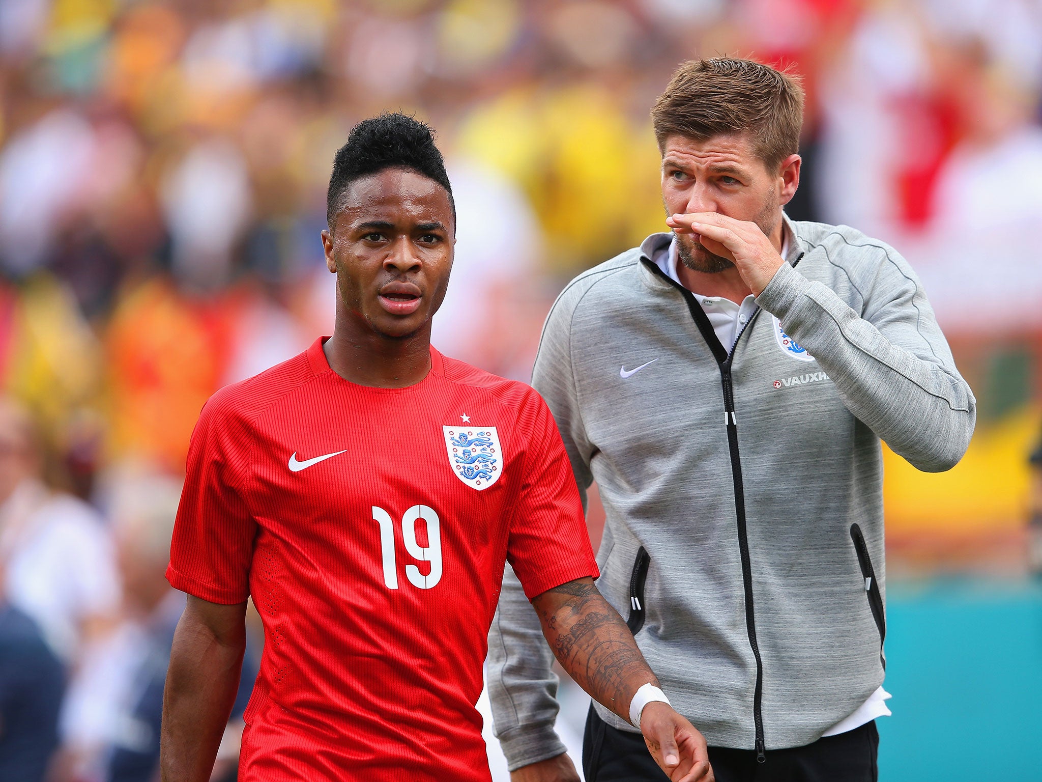 Raheem Sterling walks off the pitch in Miami alongside Steven Gerrard after being sent off for a tackle on Antonio Valencia