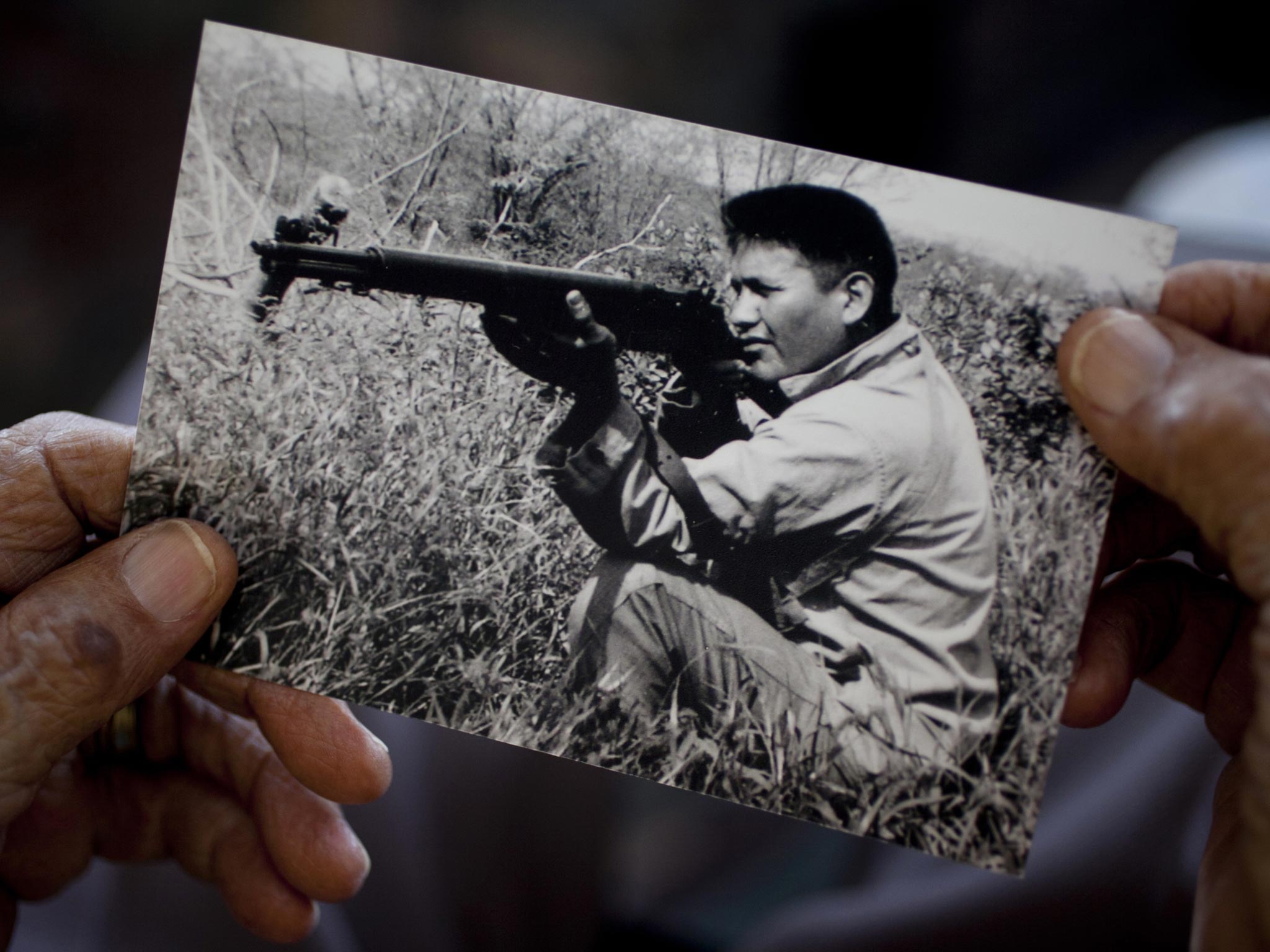 Chester Nez holds a wartime photograph of himself: he also served in Korea