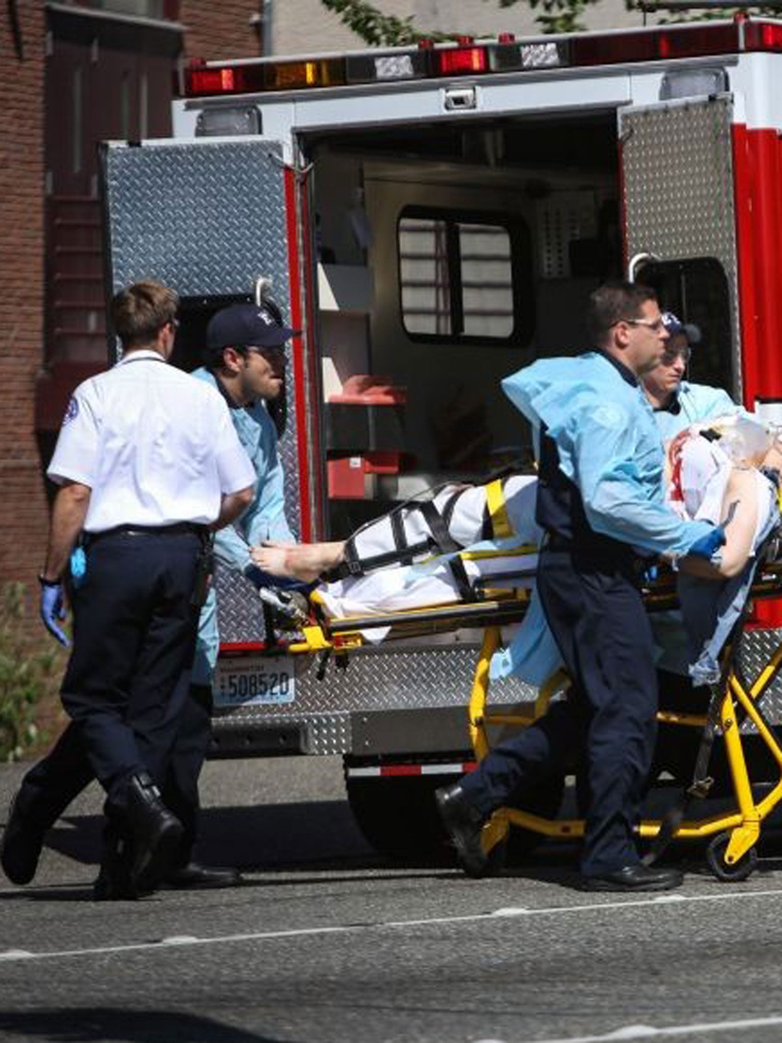 Medics wheel away a person shot at Seattle Pacific University on Thursday, June 5, 2014, in Seattle