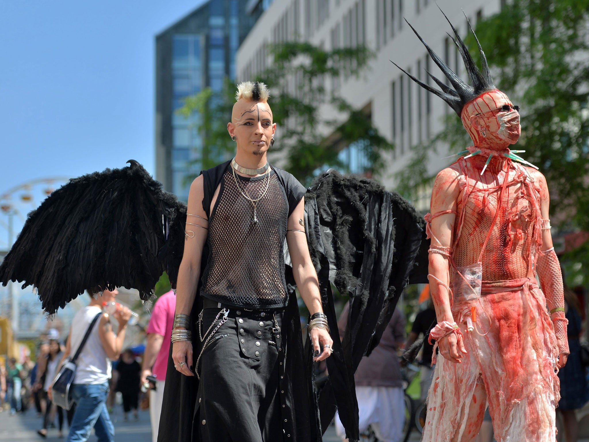 Sebastian (L) and Janosh (R) from Eisenach walk in their costumes during at the Wave-Gotik-Festival in Leipzig