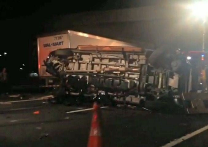 The limousine bus carrying Tracy Morgan and six other people lies on its side early Saturday morning, 7 June, 2014, on the New Jersey Turnpike