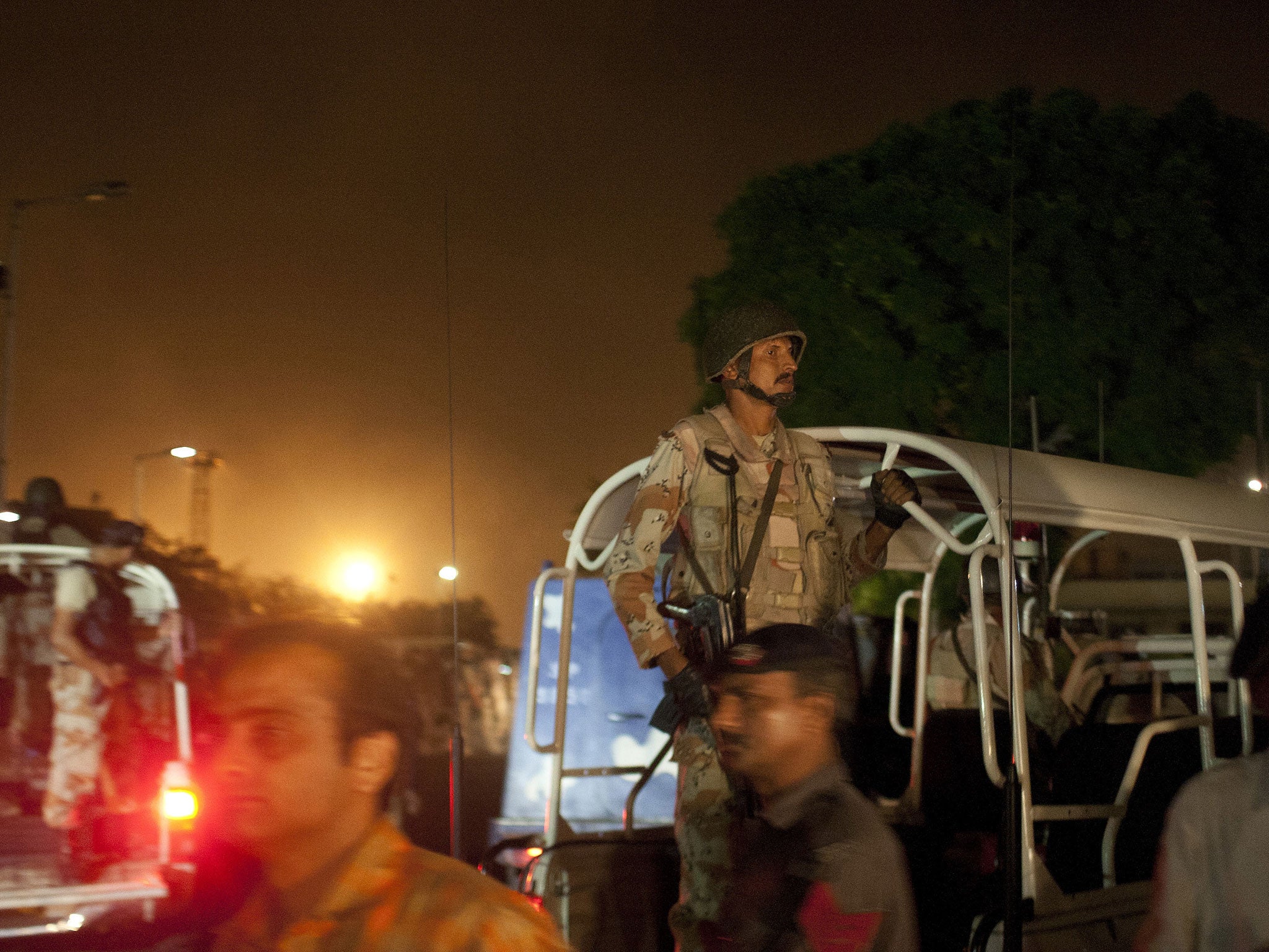 Pakistani security troops rush to Karachi airport terminal following attacks by unknown gunmen