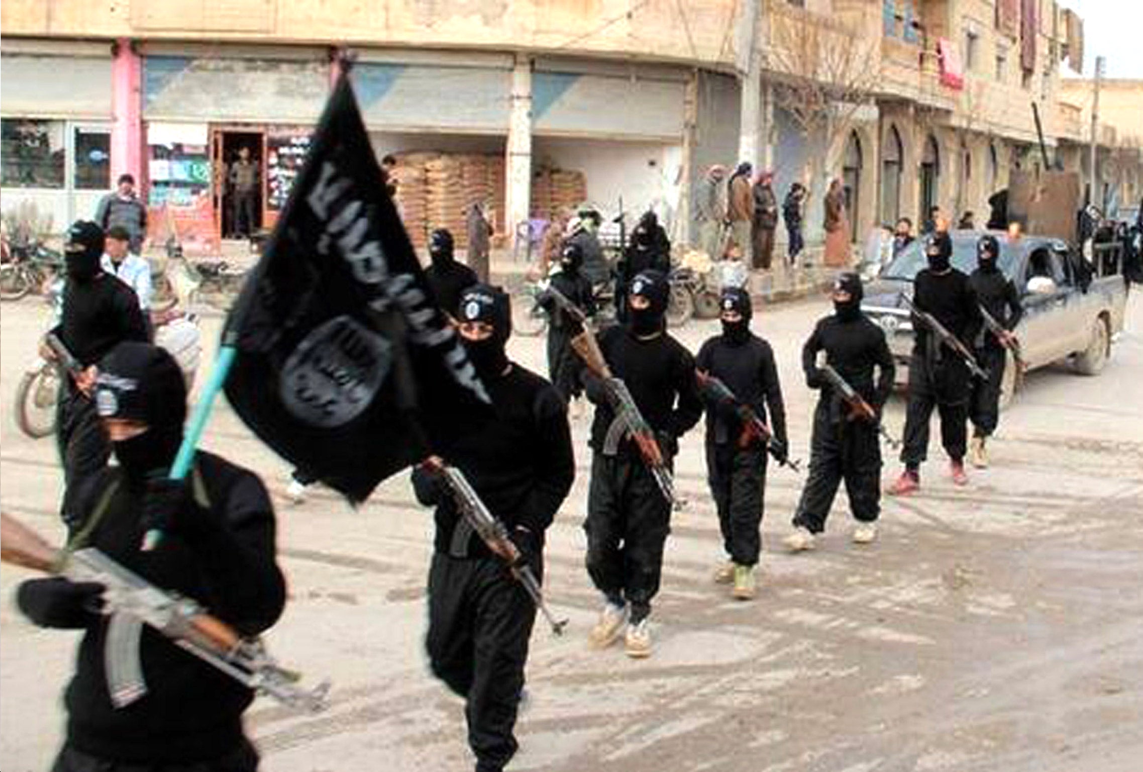 Fighters from ISIS marching in Raqqa, Syria (AP)