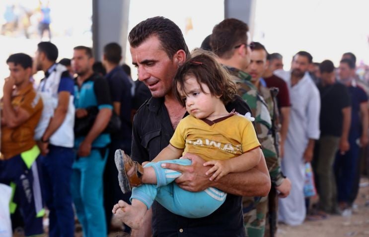 Refugees fleeing from Mosul head to the self-ruled northern Kurdish region in Irbil, Iraq, 350 kilometers (217 miles) north of Baghdad, Tuesday, June 10, 2014.