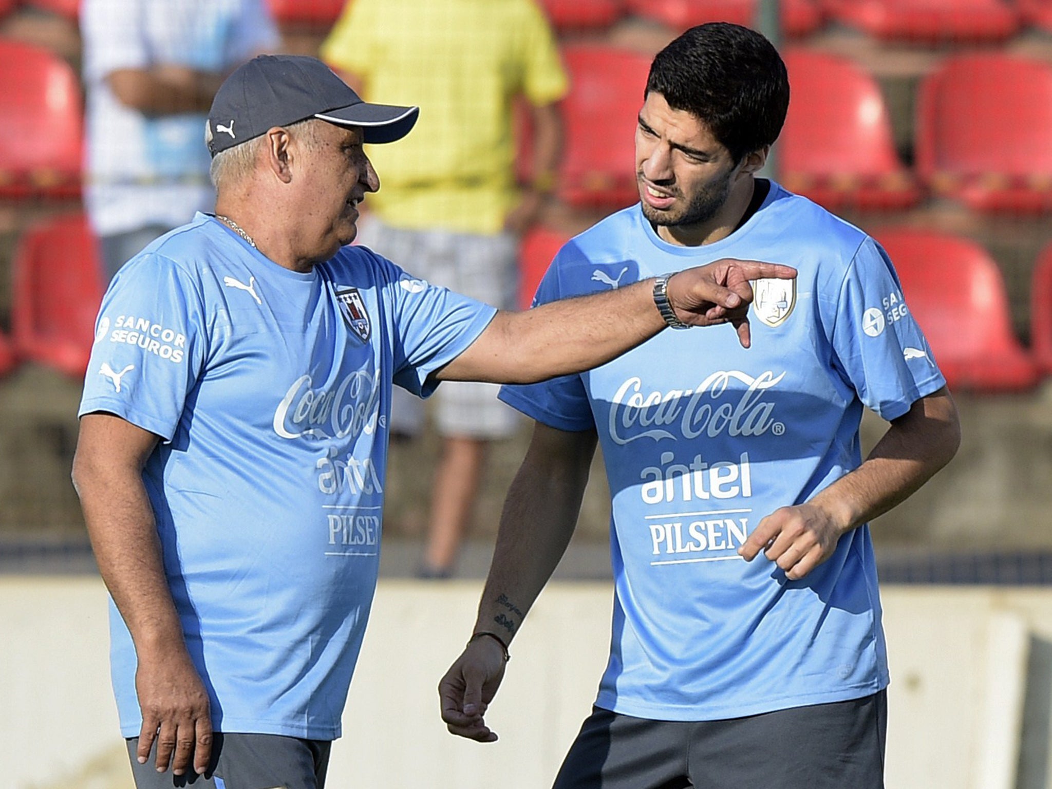 Luis Suarez listens to Walter Ferreira during his rehab