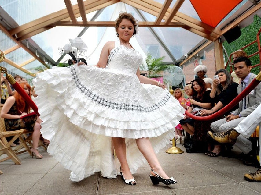 Casey Glover of Marline, Texas, shows off the toilet paper wedding dress designed by her mother, Terri Glover, during the 10th annual Cheap Chic Weddings Toilet Paper Wedding Dress Contest in New York, New York, USA, 12 June 2014. Contestants are only all