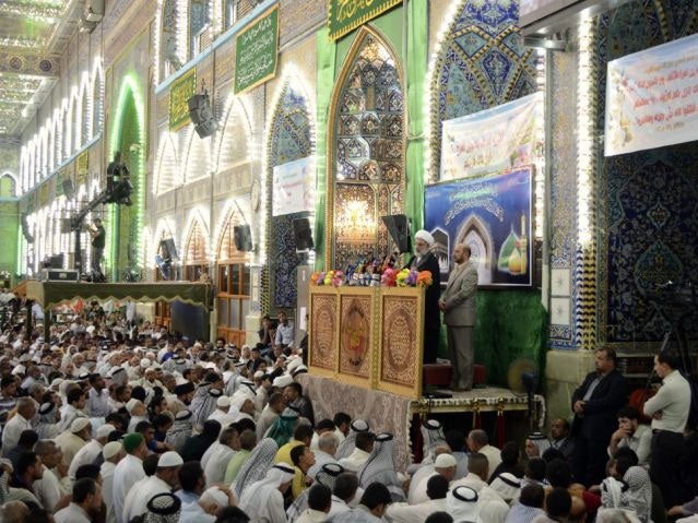 Shi'ite Muslims listen to Sheikh Abdulmehdi al-Karbalai speak during Friday prayers at the Imam Hussein shrine in the holy city of Kerbala, June 13, 2014. Iraq's most senior Shi'ite Muslim cleric urged followers to take up arms against a full-blown Sunni