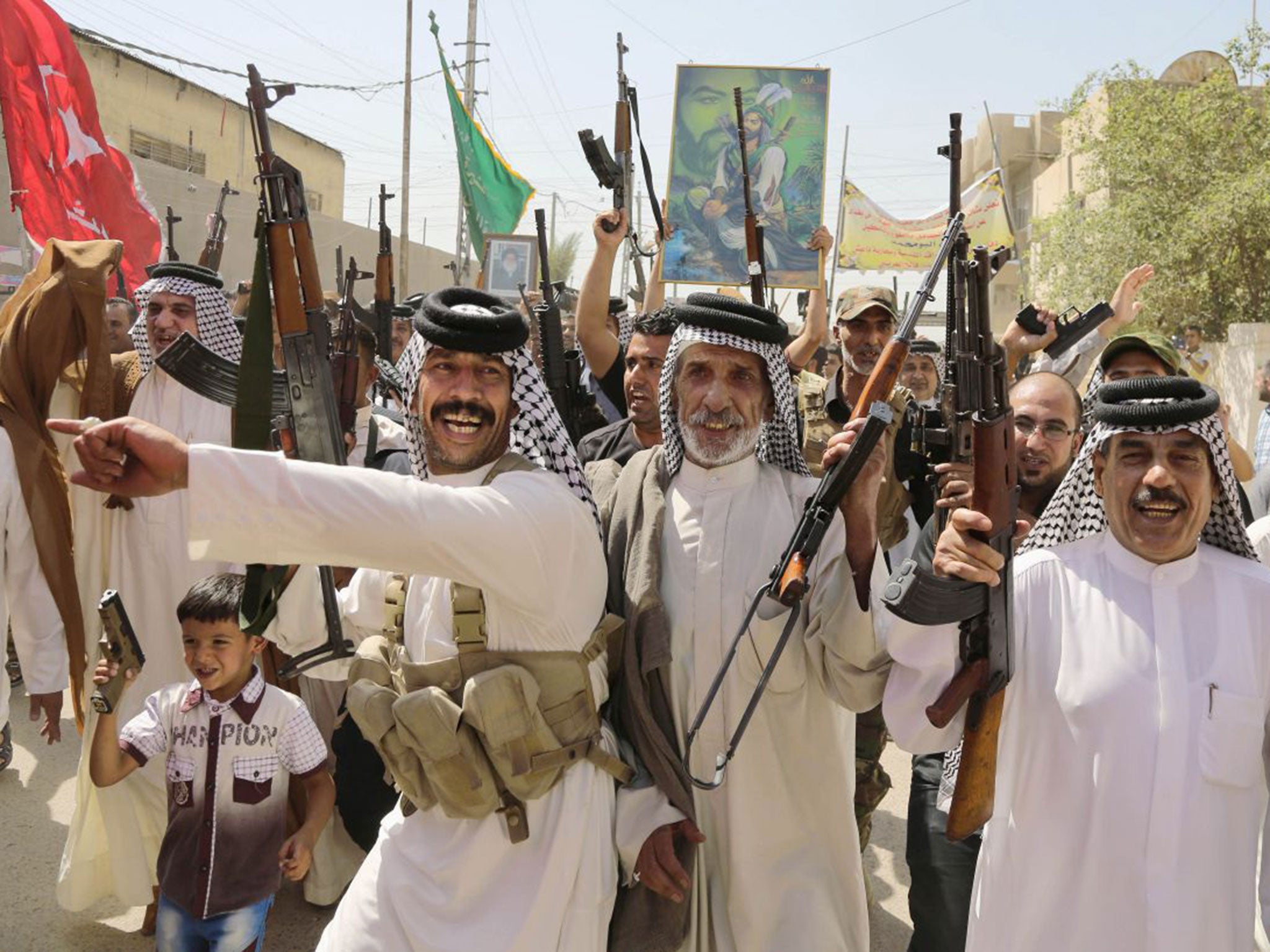 Iraqi Shia fighters chant slogans against the al-Qa’ida-inspired Islamic State of Iraq and the Levant in Baghdad’s Sadr City