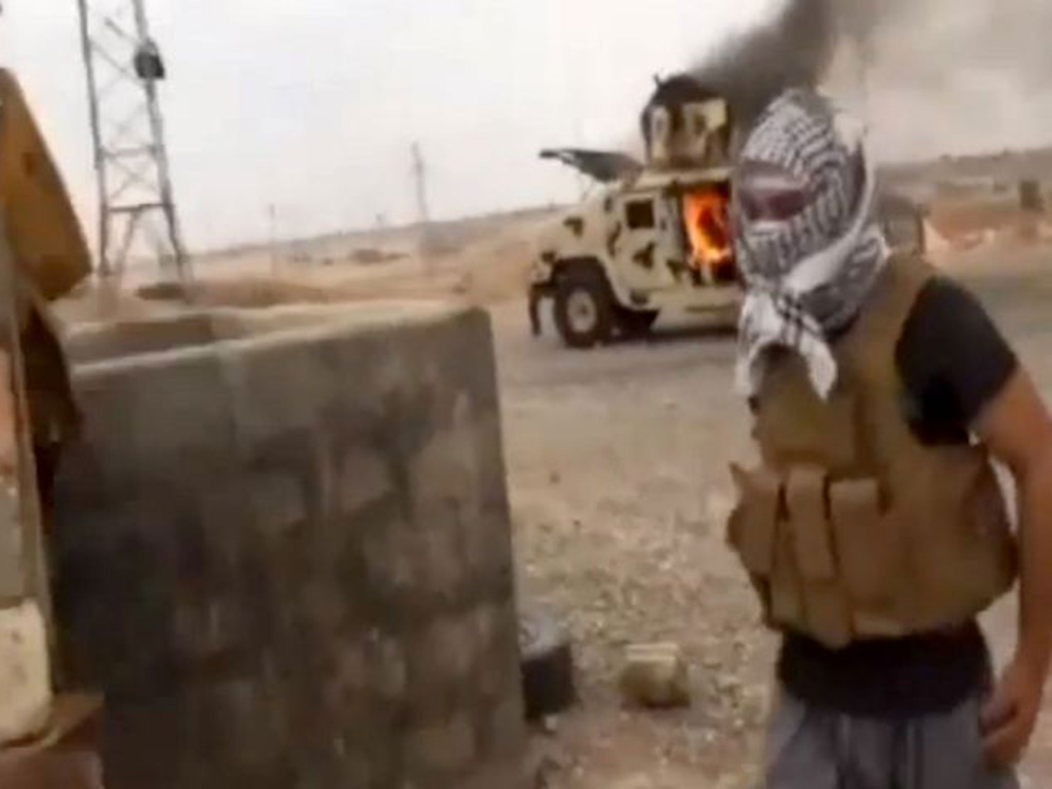 A burning Iraqi army Humvee