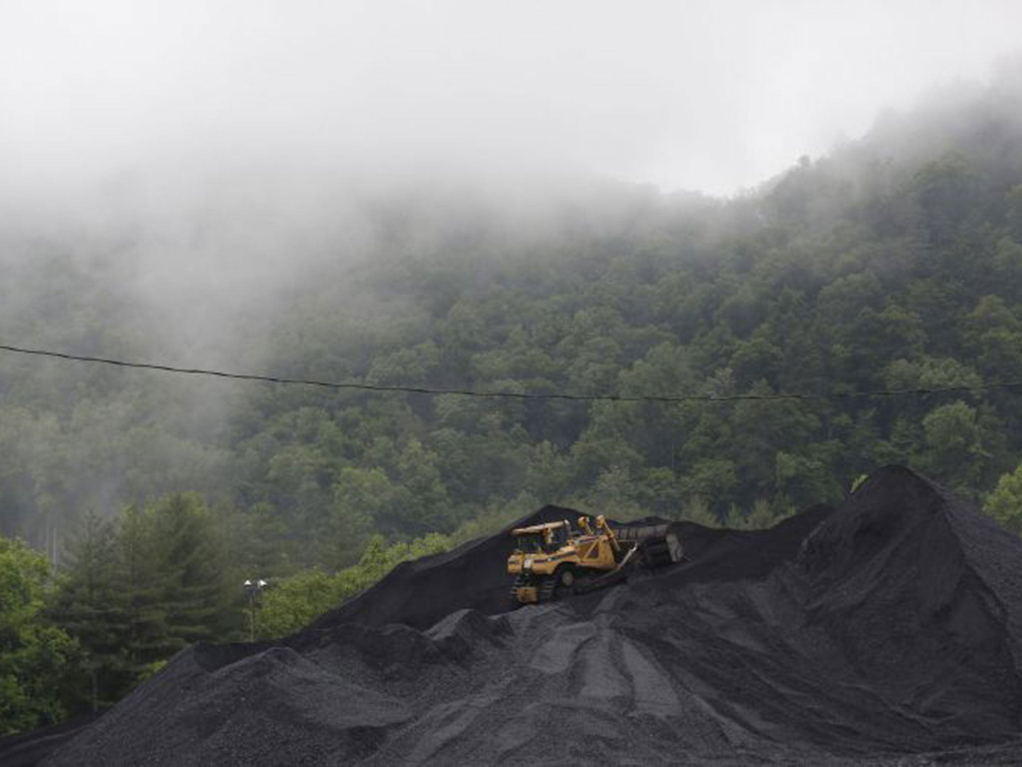 A bulldozer operates atop a coal mound at the CCI Energy Slones Branch Terminal in Shelbiana, Kentucky