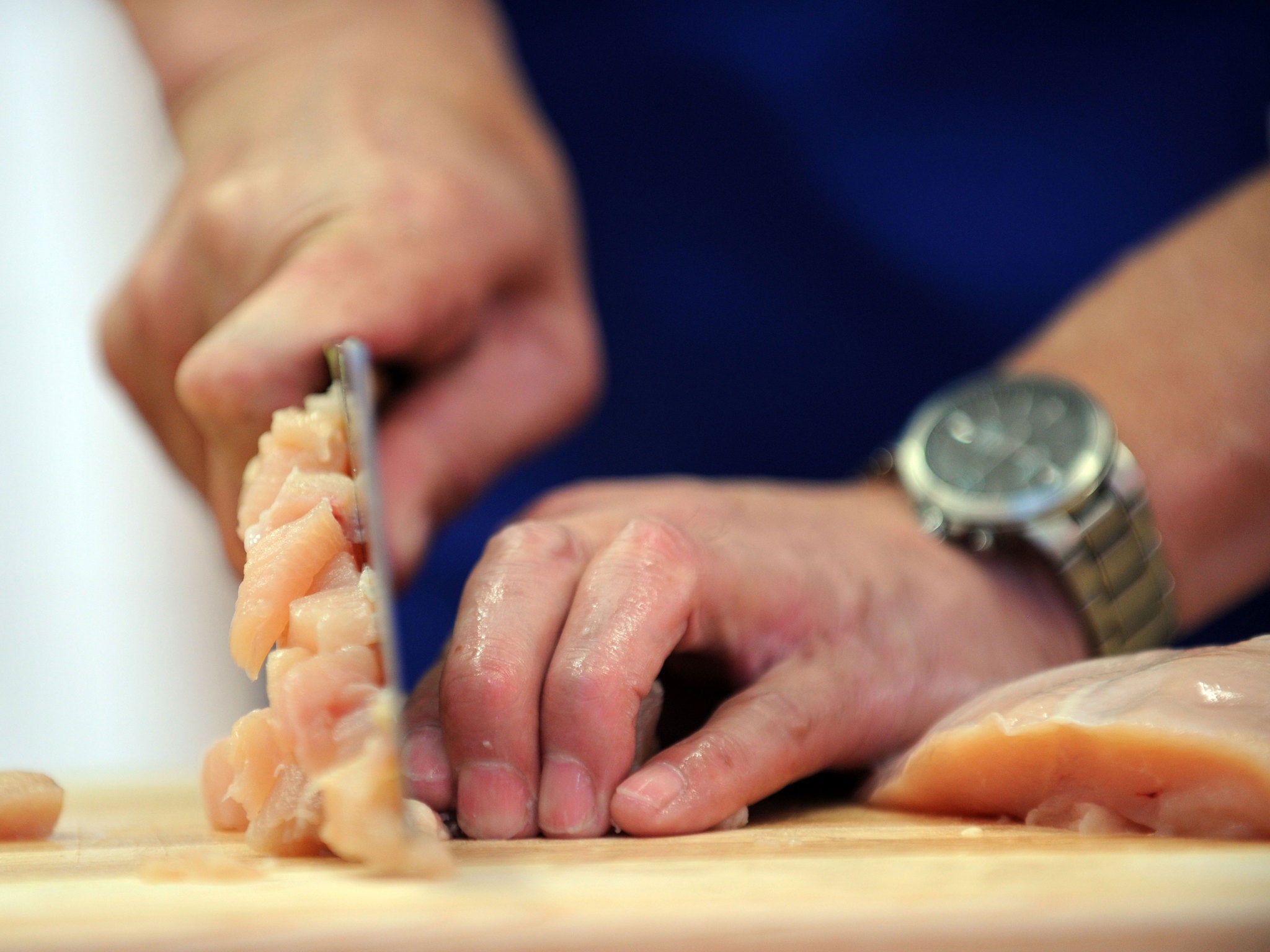 A chef slices chicken during the Third NTDTV International Chinese Culinary Competition September 30, 2010 in New York's Times Square. Five master Chinese chefs competed in a preliminary round of cooking Sichuan cuisine in the two-day open air event pitti