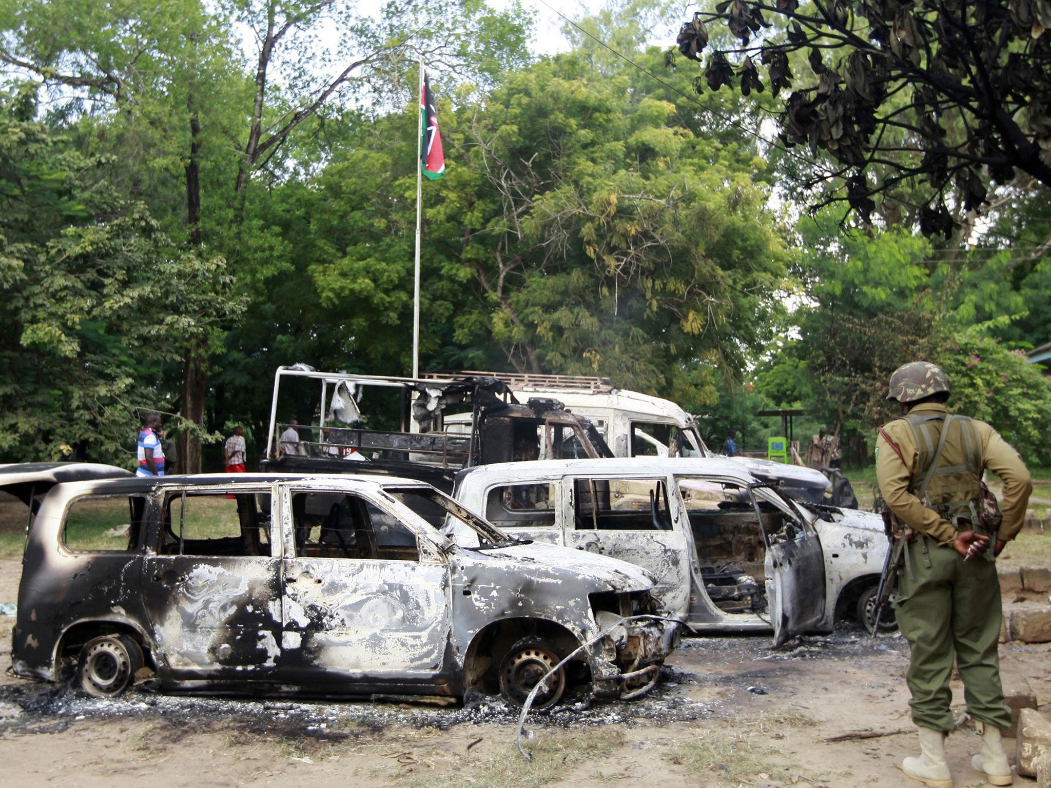 Wreckages of burnt cars are seen outside the Mpeketoni police station after unidentified gunmen attacked the coastal Kenyan town of Mpeketoni